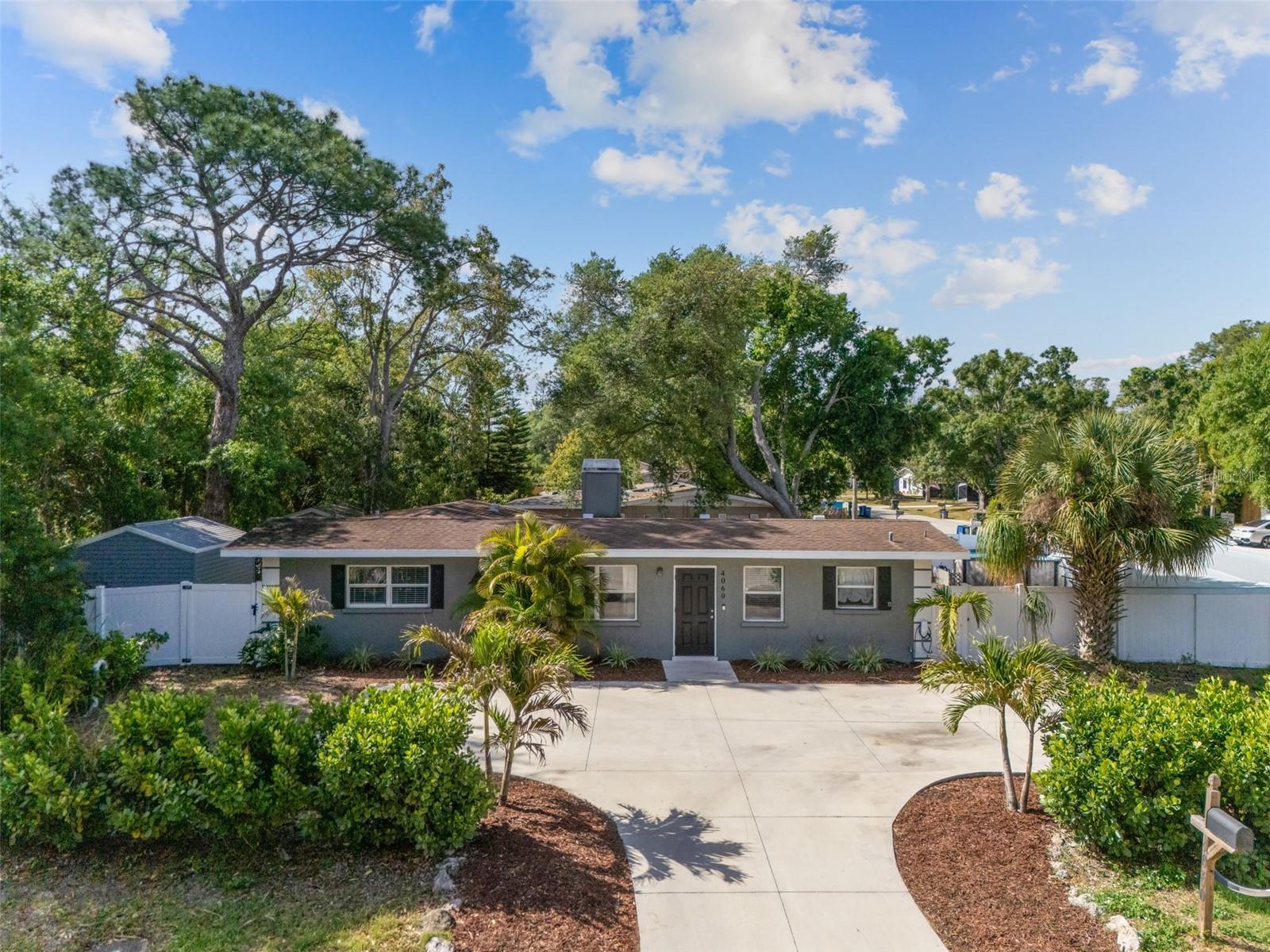 Virtually Staged. Welcome to 4060 Webber Street—an ideally located Sarasota home offering convenience, flexibility, and access to some of the area’s most sought-after outdoor amenities. Just moments from the Legacy Trail, the Sarasota Springs Trailhead, Downtown Sarasota, UTC, and world renowned beaches.  This property is perfect for those looking to enjoy all that the Florida lifestyle has to offer. The home features a comfortable layout with inviting living spaces and plenty of natural light, enhanced by luxury vinyl plank flooring throughout the main living areas and primary bedroom for a clean, modern feel. The living room is anchored by a cozy wood-burning fireplace, creating a warm focal point for relaxing or entertaining. The spacious, open kitchen offers ample room for cooking, gathering, and hosting, making it the true heart of the home. The property features a fully fenced yard with a double gate on the side, providing direct access to a concrete pad—ideal for storing a boat, trailer, or additional vehicles. With no HOA restrictions, you’ll enjoy the freedom to make the most of your property without added limitations—whether for personal use or investment purposes. Located just a short drive to Siesta Key, downtown Sarasota, shopping, dining, and major roadways, this home combines accessibility with lifestyle appeal. Don’t miss this opportunity to own a versatile property in a prime central Sarasota location