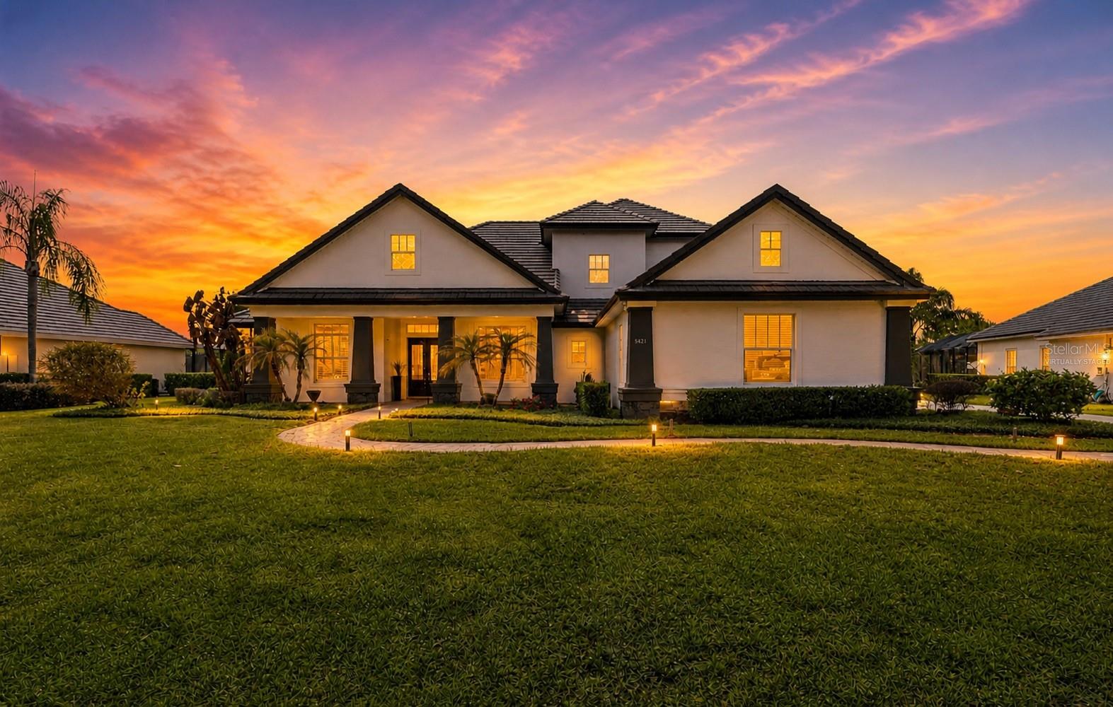 Welcome to one of Windermere’s finest offerings — an impressive 5-bedroom, 4.5-bath estate spanning almost 6,000 sq ft on a premium 0.62-acre direct water-view lot in the exclusive 24-hour guard-gated community of Tildens Grove. This is a luxury build that combines sophistication with fun and accommodates an active lifestyle for family and entertaining:  a custom private movie theater, resort-style pool with spa and panoramic screen overlooking the water, gourmet kitchen, a dedicated gym, plus two generous family / entertainment spaces upstairs and down… all create a floor plan that handles both grand entertaining and relaxed everyday living.  Updates to HVAC, lighting, fixtures, media systems, and wood flooring throughout.  Soaring ceilings with architectural features, and elegant architectural details define every room. Bedroom layout creates a lot of options with one of the downstairs bedrooms featuring a separate side entry just off of the driveway with direct access to a full bathroom - ideal for guests and multi-generational living.  Three-car garage, paver driveway, lush mature landscaping. Tildens Grove offers larger homesites and amenities including tennis, pickleball, basketball, playground, and a scenic park. Minutes to Disney World, Restaurant Row, Windermere Chain of Lakes boat ramp access, top-rated schools, quick SR-429 access for easy day trips to the beach, and approximately 30 minutes to Orlando International Airport.  Luxury, privacy, and convenience — all in one remarkable home.  Owners have this priced right so don’t delay in setting up your private showing today.