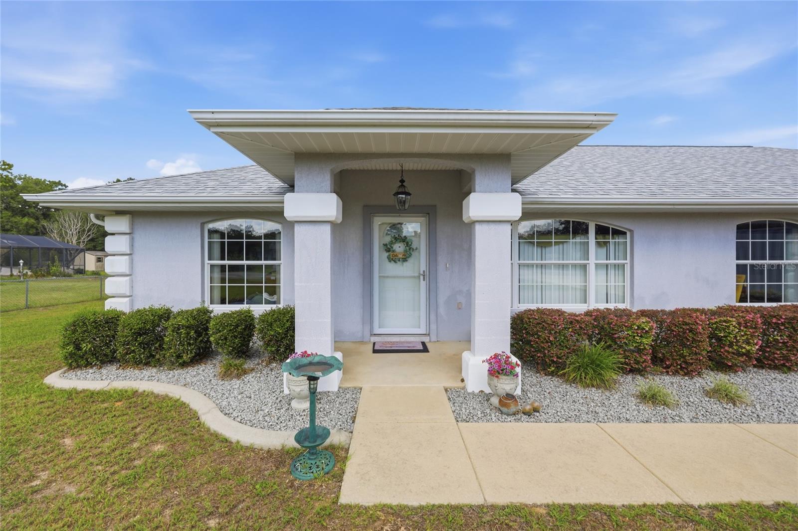 Custom-built quality, a newer roof, oversized garage space, lake access to little lake weir, and an incredible .54-acre homesite—welcome to one of Edgewater Estates' most desirable properties. This meticulously maintained 3-bedroom, 2-bath concrete block home offers 1,424 square feet of thoughtfully designed living space, an impressive 4-car garage with professionally finished epoxy floors, and a rare combination of indoor comfort and outdoor space that's becoming increasingly difficult to find.

Step inside to soaring vaulted ceilings, abundant natural light, and an inviting open-concept floor plan designed for both everyday living and entertaining. The spacious kitchen features generous cabinetry, ample countertop space, and flows seamlessly into the dining and living areas, creating a bright and welcoming atmosphere. The desirable split-bedroom layout offers privacy for the owner's suite while providing comfortable accommodations for family and guests.

The oversized screened lanai serves as an extension of the home, creating the perfect space to enjoy morning coffee, evening sunsets, or gatherings with family and friends while overlooking the expansive backyard. Outside, you'll find a well-maintained above-ground pool, ideal for cooling off during Florida summers, along with a storage shed that provides additional space for tools, lawn equipment, or recreational gear.

The true showstopper is the massive .54-acre lot. Beautifully maintained and mostly fenced, it offers endless opportunities for outdoor living with ample room for entertaining, future gardens, additional outbuildings, RV or boat parking, or simply enjoying the privacy and open space that larger homesites provide.

Car enthusiasts, hobbyists, and anyone needing exceptional storage will appreciate the oversized 4-car garage featuring durable epoxy-coated floors, offering abundant space for vehicles, workshops, recreational equipment, and more.

Residents of Edgewater Estates enjoy private community access to Little Lake Weir, where you can spend your days boating, fishing, kayaking, paddleboarding, or simply taking in the beauty of one of Marion County's most sought-after lakes.

Perfectly situated just minutes from The Villages, Belleview, and Ocala, you'll enjoy convenient access to shopping, dining, healthcare, golf courses, entertainment, and everyday conveniences while still experiencing the peaceful charm of a quiet residential community. With easy access to US-441 and SE Highway 42, commuting throughout Central Florida is effortless.

Whether you're searching for your forever home or a peaceful Florida retreat, 14460 SE 98th Court offers the rare combination of custom concrete block construction, a newer roof, oversized 4-car epoxy garage, screened lanai, above-ground pool, storage shed, private Little Lake Weir access, and a sprawling .54-acre homesite—a truly exceptional opportunity in Edgewater Estates.