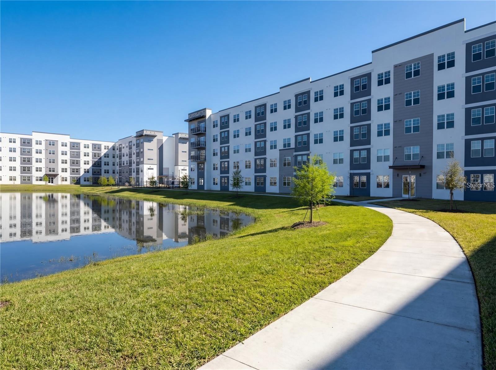 Experience modern living at its finest in this brand-new, move-in ready 1-bedroom + den, 1-bathroom condo located in the highly sought-after Millenia Park community. Already completed and delivered, this home is available immediately—no construction delays, no waiting, just the opportunity to move in or start generating rental income right away.

Designed with comfort and style in mind, this bright open-concept residence features elegant contemporary finishes, soaring 9-foot ceilings, and large windows that fill the space with natural light. The sleek gourmet kitchen showcases stainless steel appliances, granite countertops, and abundant cabinetry, seamlessly connecting to the spacious living and dining areas—perfect for both everyday living and entertaining.

The versatile den provides the flexibility to create a home office, guest room, or cozy media space to fit your lifestyle. The spacious primary bedroom offers comfort and privacy, while the modern bathroom and in-unit washer and dryer add everyday convenience.

Residents of Millenia Park enjoy exceptional resort-style amenities, including a sparkling swimming pool, clubhouse, state-of-the-art fitness center, tennis court, dog park, scenic walking trails, and beautifully maintained green spaces.

Ideally located just minutes from Orlando’s premier shopping, dining, and entertainment at Millenia, with easy access to major highways and attractions, this property offers the perfect combination of luxury, convenience, and investment potential.

Whether you’re searching for your next home or a turnkey investment property, this is an opportunity you don’t want to miss. Schedule your private showing today before it’s gone!