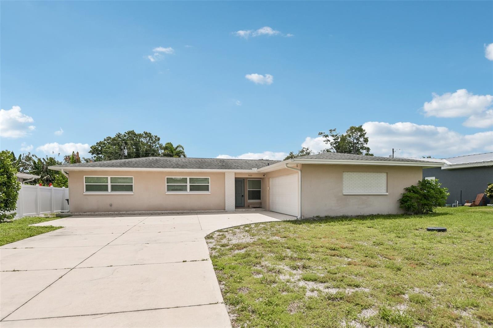 Virtually Staged. Fabulous layout, located in a desirable Pinellas County neighborhood. This move-in-ready 4-bedroom, 3-bathroom, 2-car garage block home features major practical upgrades and an excellent location. The property offers incredible peace of mind with all major infrastructure recently updated and classic, low-maintenance, newly polished stunning TERRAZZO FLOORS throughout. Key improvements include a new roof (2021), a whole-house generator (2021), and impact-resistant hurricane windows. Additionally, the A/C, tankless water heater, garage door, 200-amp electrical panel, and all plumbing and sewer lines were completely updated in 2020. Inside, the eat-in kitchen features granite countertops, solid wood cabinets, a pantry, and corner windows that bring in plenty of natural light. The main living and dining areas open directly into a spacious bonus room that works great for entertaining and  just everyday ease of living. The bedrooms are well-sized with ample closet space and all bathrooms are updated with contemporary tile and finishes. Situated in a non-flood zone where no flood insurance is required, this home is just a short drive or a 10-minute bike ride to the Belleair Causeway, the beach, Taylor Park, Largo Medical Center, excellent restaurants and local shopping. Don't miss this one, make your appointment right away!