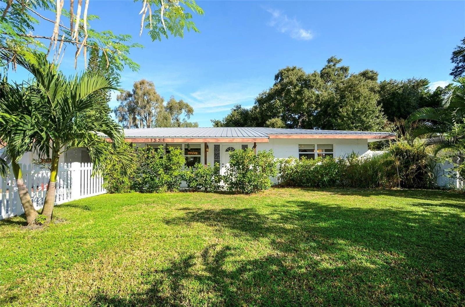 Charming inside and out. This 3 bedroom 2 bath split floor plan features easy-care vinyl plank flooring, light filtering custom shades on all windows, plenty of closet space, covered carport and separate laundry. Step outside this spacious home and the lovingly tended and beautifully landscaped backyard will surely be your new happy place. The perfect space to relax, create and entertain with plenty of room to play.  Are you relocating or getting to know the area? The location is convenient to all the area offers. Ringling College of Art and Design is a half mile away, Bay Park Conservancy is a mile and the vibrant downtown is just beyond. Convenient to USF, New College, Fruitville, Bradenton and University. The beautiful Gulf and Lido beach are 3.1 miles away. This is an annual UNFURNISHED rental but the owner can leave furnished if needed.  Dogs (non-agressive breeds) considered with a pet deposit. There is a $50 application fee per adult tenant for background check and income verificaton.
