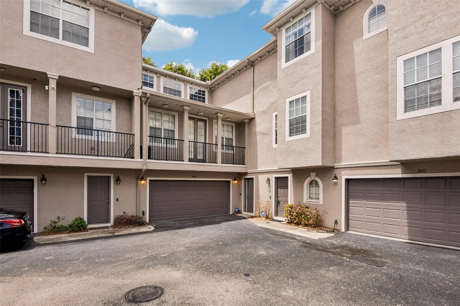 Virtually Staged. Located in South Tampa’s highly sought-after Plant High School district, this elegantly remodeled, 2,741-square-foot townhome offers an incredible, low-car-dependence lifestyle just minutes from downtown and the airport. It is 2 blocks to Publix, Hyde Park, and all the dining and entertainment in SoHo, all while enjoying the peace of mind of being in a non-flood zone with quick access to the Selmon Expressway and I-275. Inside, the home features a brilliantly designed layout with high-quality finishes and essential recent updates, including a newer roof, A/C, water heater, fresh carpet (in some bedrooms), a new washer and dryer, and a replaced primary bath fan mechanism. The massive two-car garage easily pulls double duty as a home gym or workshop with plenty of room left for a vehicle. The living spaces are beautifully spread across three floors: the first floor hosts an additional living/lounge area and guest suite; the second opens up to gorgeous hardwood flooring, an oversized primary suite with a spa-like bath, and an incredibly ergonomic designer kitchen with stunning quartz waterfall countertops; and the third floor features two additional bedrooms alongside a dedicated bonus room that's absolutely perfect for a home office or 5th bedroom . Schedule a showing today!