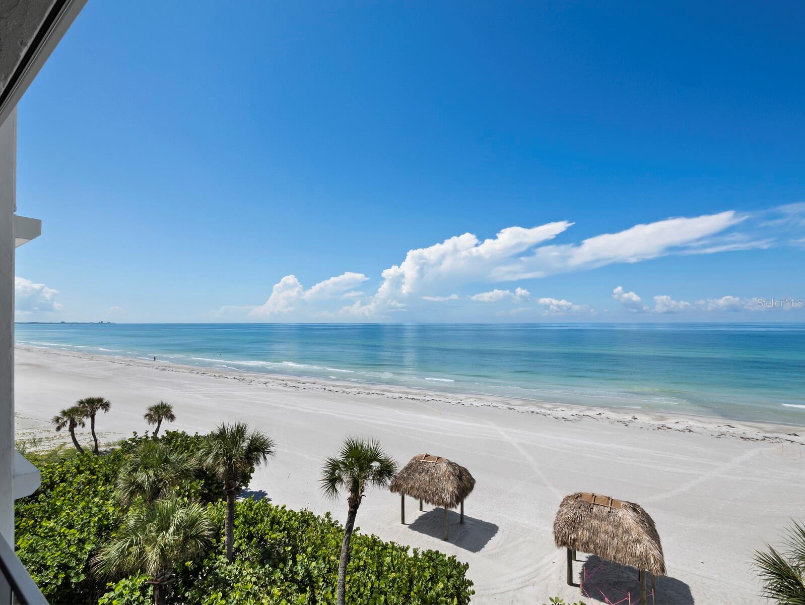 This exceptional beachfront paradise offers a rare opportunity to own one of just 10 exclusive condominiums in a boutique-style building situated directly on the sand in the highly sought-after Longboat Key. Uniquely positioned next to The Residences of the renowned St. Regis Resort, this property offers the perfect blend of tranquility and luxury. Enjoy a private, serene beach right outside your door, while also having full access to the world-class amenities at the St. Regis, thanks to a membership that transfers with your purchase.
As you arrive through a secure gate and follow the long driveway, you'll immediately sense the uniqueness of this one-of-a-kind property. With secure access through the small lobby, the elevator ushers you to the third floor - shared with just one other residence. Inside, nearly 3000 sf of beautifully renovated interiors open to sweeping, uninterrupted views of the Gulf of Mexico.  The spacious living, dining and kitchen areas flow seamlessly to a large, covered balcony that will surely become your favorite place to soak in the incredible Florida sunsets. Each of the 3 bedrooms and 3 baths have access to their own balconies as well, and all have beautiful views. There is plenty of room for entertaining family and friends or to just enjoy the tranquil breezes and the remarkable quality of life this extraordinary residence can offer. The exceptional location is close to many nearby restaurants, the world-famous shopping of St.Armands Circle and the cultural epicenter of downtown Sarasota. A must see for anyone looking for a balance of laid-back island luxury and the island lifestyle that Longboat Key is known for.