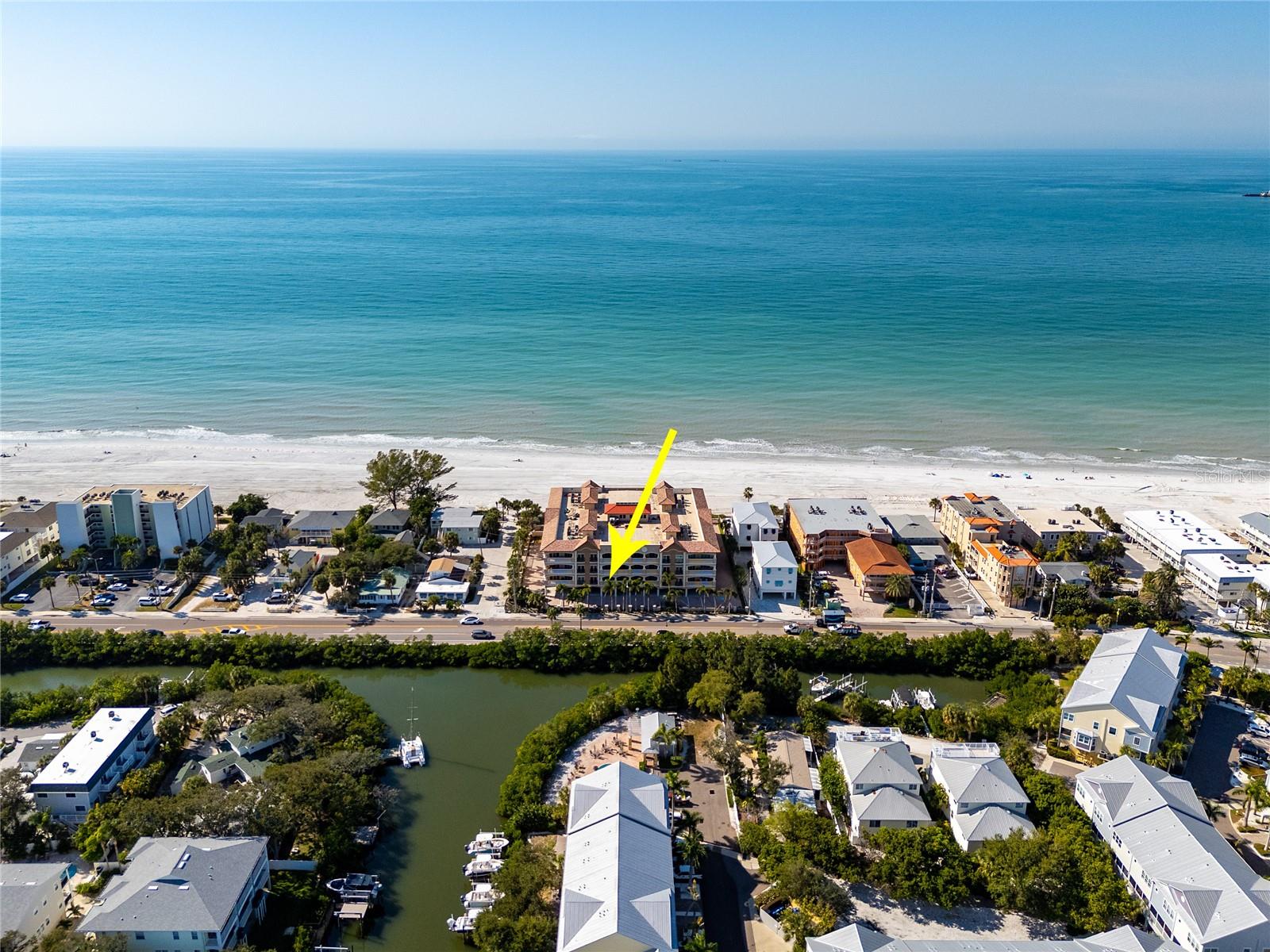 Bella Capri, built in 2009, is an intimate, gated beachfront community featuring only 24 residences, providing exceptional privacy along the shores of Indian Rocks Beach. Designed with both elegance and strength in mind, the community features concrete/block construction, elevated living floors, impact-resistant windows and doors, dual exits, and an advanced fire-suppression system for exceptional peace of mind. Arrive through the gated entrance to beautifully maintained grounds with four secure lobbies and four elevators—each serving only six residences—enhancing comfort, privacy, and exclusivity. This luxurious three-bedroom, three-bath residence is ideal as a full-time coastal home or refined vacation retreat. Inside, a gourmet kitchen offers elegant finishes, premium cabinetry, and a generous walk-in pantry with built-in trash chute. The primary suite provides a private sanctuary with a spacious walk-in closet and spa-inspired bath featuring a rain shower and Roman soaking tub. Each additional bedroom includes its own en-suite bath, with convenient access to the building atrium. The interior is beautifully appointed with premium finishes, including 10-foot tray ceilings, crown molding, travertine flooring, and engineered hardwood. A private laundry room, abundant storage, and an additional owner’s storage closet in the private foyer add everyday convenience. Residents enjoy 200 feet of direct beachfront, along with a heated saltwater pool and spa overlooking the Gulf. The east-facing patio provides tranquil morning sun and a peaceful place to unwind at the end of the day. Two assigned parking spaces and guest parking complete the offering. Indian Rocks Beach offers the best of relaxed coastal living with charming local restaurants, parks, and beach access points just moments away, and convenient proximity to Tampa International Airport and St. Pete–Clearwater Airport.
