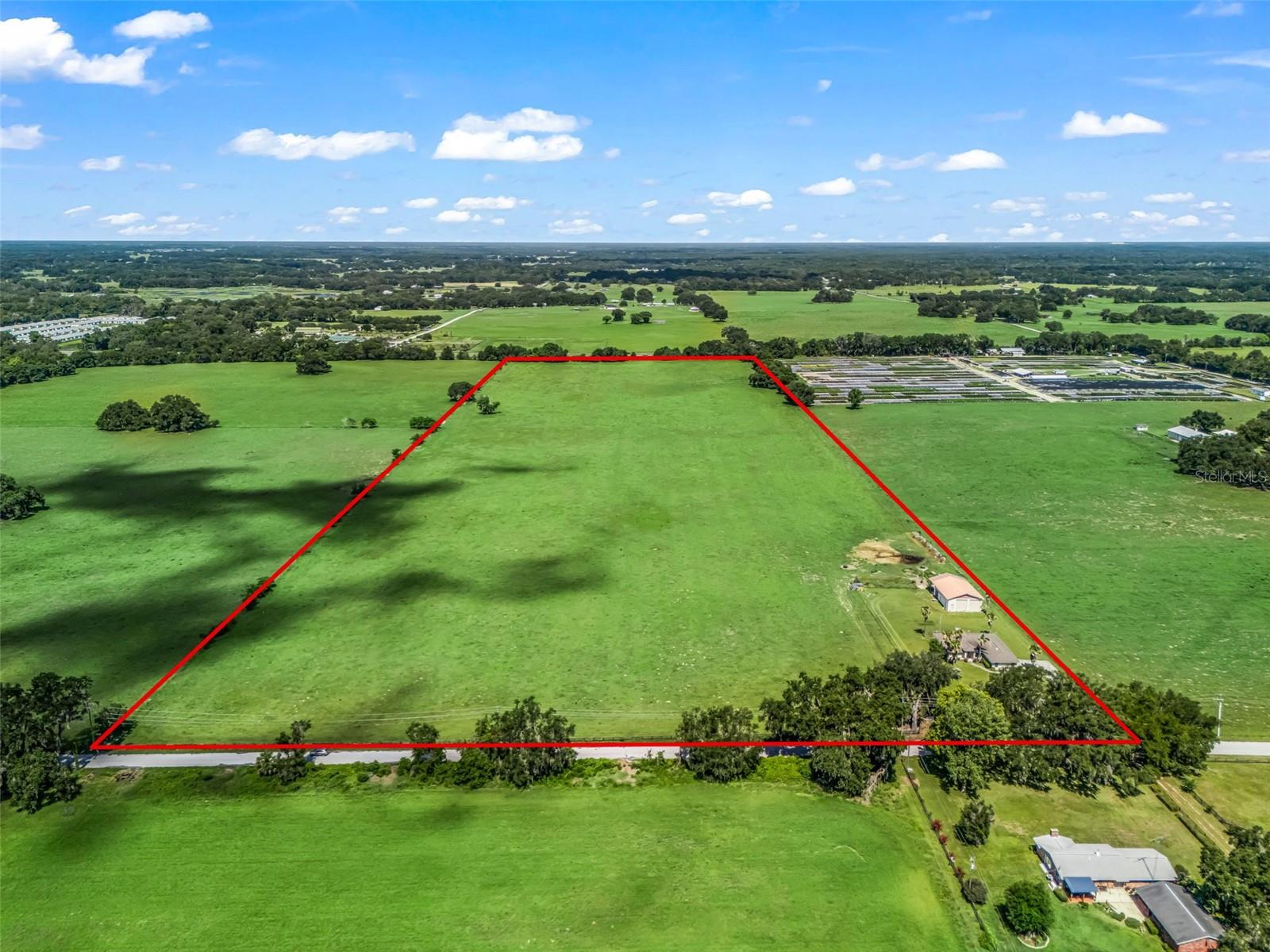 DON'T MISS THIS OPPORTUNITY! 
I would like to invite you to take a look at a beautiful, open property
located in a prime area in Oxford, Florida, close to the heart of The Villages.  This 48-acre parcel is situated on
County Road 103 less than ¾ of a mile from medical facilities, shopping, restaurants, schools, and other desirable
amenities.  The property is flat, high, and dry, completely cleared, with approximately 800 feet of frontage on 
County Road 103.  City of Wildwood utilities are approximately 1800 feet South on County Road 103.  It's 
conveniently close to offices, an Assisted Living Facility and Walmart.  Residential Development could be
considered with possibilities for Agriculture Conservation as well as "Estate Homes."  The potential includes possibly 15 to 16
homesites, ranging from 1 to 2-Acre Parcels.  Endless possibilities include possible horse stables, barnes, arenas or just a pristine development for a horse farm community.  This is an excellent opportunity for development, investment,
10-31 Exchange and/or other future use for monetary gains.
Additional property features include a 2400 Sq Ft Home, Large Workshop, Storage Building, Covered RV and Boat
Storage, excellent visibility from US Hwy 301.  This Property offers tremendous potential in a
rapidly expanding area.
Due to circumstances, there is a substantial price reduction offered for all investors and land acquisition developers.
The owners are motivated to sell this prime investment property.