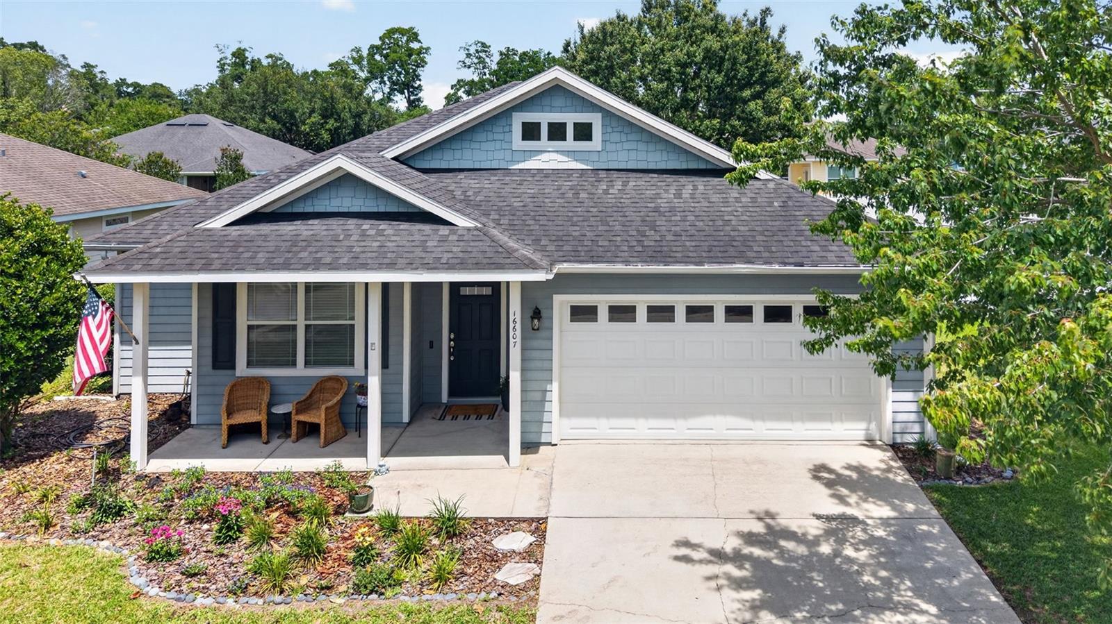 Welcome to your new home in the charming Oak Ridge neighborhood of High Springs, where an inviting front porch sets the tone and offers the perfect spot to relax before stepping inside. This beautiful three bedroom, two bathroom home features an open floor plan that blends comfort and style, with main living areas showcasing engineered hardwood flooring, soaring nine foot ceilings, and crown molding in the main living room and primary bedroom, along with a spacious kitchen and family room combination ideal for everyday living and entertaining. The modern kitchen includes new quartz countertops, stainless steel appliances, and a dishwasher that is only three years old. The thoughtfully designed split floor plan provides privacy, with the owner’s suite set apart from the two front bedrooms. Luxury vinyl plank flooring runs throughout the bedrooms with no carpet in the home. An indoor laundry room is conveniently located off the kitchen before entering the garage. Beautiful French doors lead out to the backyard oasis, where the fenced yard delivers both privacy and functionality with a smart irrigation system, an extended paver patio, and beautiful crepe myrtles that create a serene outdoor setting. The AC is approximately three and a half years old, offering added peace of mind. A two car garage provides plenty of parking, and the neighborhood sidewalks are perfect for evening strolls. This is a home you do not want to miss.