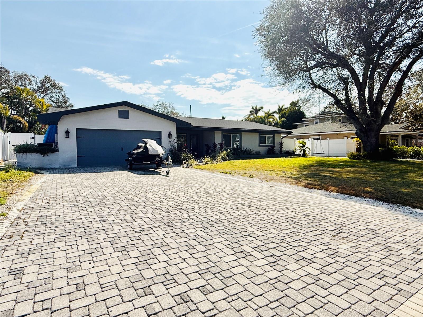 Beautiful move in ready home with peekaboo views of Boca Ciega Bay! Completely updated 4 bed , 2 bath , large heated pool & hot spa, oversized 2 car garage and inside laundry room. Newer roof, electrical, plumbing, impact windows, doors, paint inside and out , wood look tile floors and no interior flood damage from recent hurricanes . Open floor plan catering to the oversized 11ft island with custom cabinets ,  large pantries, spice rack , wine rack and pull out trash can . Appliances are all newer to include a dual convection oven. The master retreat has 9 foot ceiling , large walk in closet and multiple large windows overlooking the pool. The house has 3 bedrooms  on the other end with a shared bathroom. There is also an inside laundry room before the garage. The backyard allows serenity with the spa waterfall that fills into the oversized pool. The tropical trees add a sense or paradise and add to the low maintenance of the astro turf.  The driveway has plenty of room for parking plus a separate paved driveway for a boat/trailer/rv. . Free boatramp nearby, 10 min to beaches and downtown.