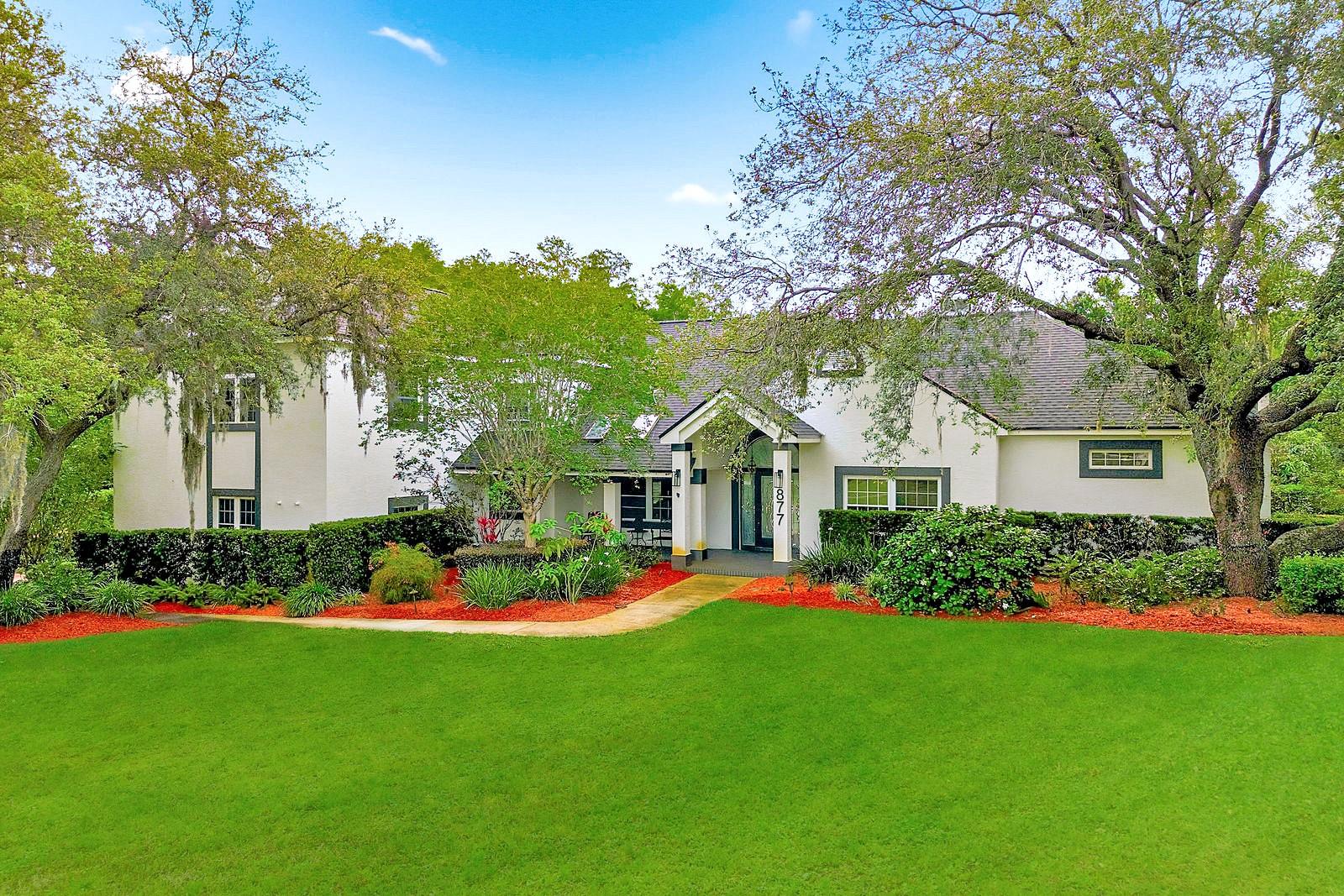 Privacy prevails on this custom home nestled on over an acre of land with private access to a 6 acre lake! This gorgeous home is located in a sought after community of Cypress Lakes Estates which offers over sized estate lots which is a rare find and A+ schools! Unique architectural features focus on the lifestyle of Florida outdoor living yet with a very spacious home with 5328 sq. ft. of living area. The home offers an attractive floor plan with 5 bedrooms, 6 bathrooms, living room with an inviting wood burning fireplace, a formal dining room, office/study, spacious kitchen with marble counter tops, center island/breakfast bar, upgraded stainless steel appliances with an additional dining area plus coffee bar. The primary bedroom is located on the main floor with a private bathroom, large vanity with two sinks, large walk in shower and walk in closets. There is an additional bedroom and full bathroom on the main floor. There are three bedrooms which are generous in size located on the third level with private bathrooms for each bedroom. There is room for everyone! The first floor offers a theater room, full bathroom, gym and bonus/flex room which could be used as an additional bedroom. Walk right out to the large pool and over sized lanai. A great space for outdoor entertaining. Take a stroll down the wood walk way to your private access area of the lake! Such a tranquil and inviting setting! The home also offers a whole home generator system 2022 - New Roof 2026 - New Gutters 2026 - Water Softener, Gas Tankless Water Heater, Gas Range. There is a side entry 3 car garage which is over sized. Relax out on the multiple decks this home has, all overlooking your private sanctuary.