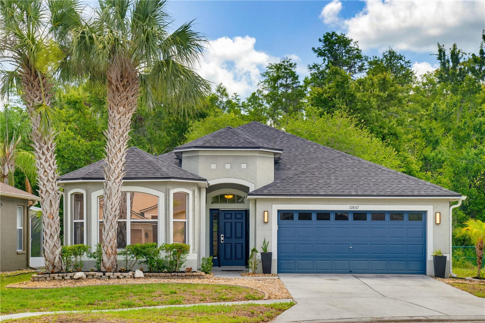Beautiful and elegant 3 bedroom, 2 bath, 2 car garage home on a conservation lot in the community of Suncoast Lakes in Land O Lakes, Florida, Tampa Bay’s northern suburb. Entering through the dramatic foyer with warm lighting, you’ll arrive at the open-concept living room and dining area providing lots of flexibility and is just perfect for entertaining. Large sliding glass doors invite you to enjoy the rear of the property, which is like your very own private oasis with lush vegetation, an enclosed/screened porch perfect for enjoying the view, grilling and a back yard that lends itself to a small fire pit and privacy. The kitchen, with granite countertops and plenty of cabinet space, has both a breakfast bar and breakfast nook. Bedrooms are arranged in a split floor plan. The Primary Suite is spacious with the bathroom having dual vanities, tub, large walk-in shower, separate commode room and an ample walk-in closet. The second bedroom has bay windows and the third bedroom can alternatively be used as an office with French doors. Other features of this home include upgraded ceiling fans/lights in each room and electric fireplace in the living room. All appliances are included. No CDD, low HOA and flood insurance is not required. COMMUNITY AMENITIES:  Pool, Clubhouse, Tennis, Basketball, Volleyball, Playground and exclusive neighborhood access to the Suncoast Trail. LOCATION:  Publix (7 mins), Walmart (20 mins), Hudson Beach (24 mins), Tampa International Airport (30 mins), Downtown Tampa (43 mins) and 5 minutes to the Suncoast Parkway/589 with quick access to all the restaurants, shopping, and entertainment for which the Tampa Bay area is known. Request your showing today!