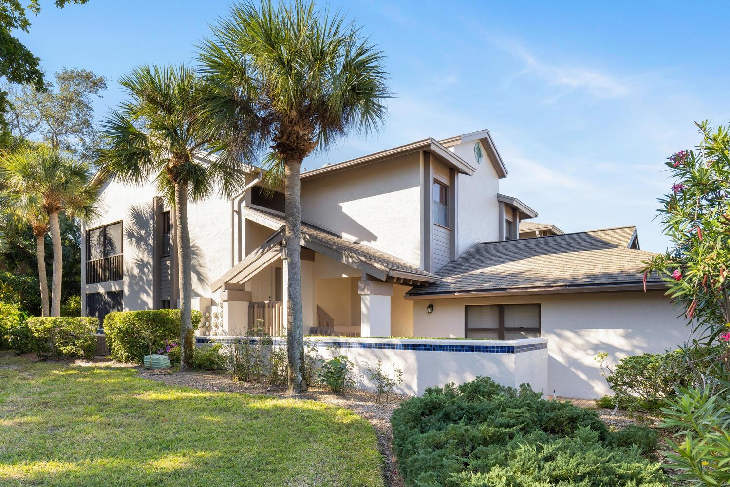 One or more photo(s) has been virtually staged. Discover the perfect blend of space, comfort, and opportunity in this desirable three-bedroom, two-bath end-unit condominium located in the highly sought-after gated community of The Landings. Enter through the welcoming first-level foyer and ascend to the light-filled main living area, where vaulted 13-foot ceilings create an airy, open ambiance. With approximately 1,775 square feet of living space, this residence offers a well-designed split floor plan that ensures privacy while maintaining an effortless flow for everyday living and entertaining. The living and dining areas seamlessly connect to the kitchen, complete with a convenient pass-through bar—perfect for hosting gatherings or casual dining. The spacious primary suite serves as a relaxing retreat, featuring a large walk-in closet and an oversized ensuite bath with dual sinks and a spa-inspired shower. Two inviting guest bedrooms provide comfortable accommodations for family or visitors. Enjoy peaceful moments on the screened lanai, surrounded by lush natural scenery, or take advantage of the attached one-car garage for added convenience. As a resident, you’ll have access to The Landings Racquet Club, offering 8 Har-Tru tennis courts, pickleball, a heated swimming pool and spa, fitness center, meeting rooms, and a library—the perfect extension of your home and lifestyle. Set within a secure, 24-hour guard-gated community, The Landings is renowned for its scenic walking trails, lush tropical setting, and direct access to Sarasota Bay. Ideally situated near top-rated schools, world-class dining, shopping, arts, and the beautiful Gulf Coast beaches, this community embodies Sarasota living at its finest.