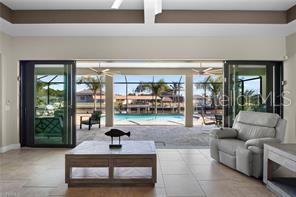 ***Due to medical reasons, sellers are motivated. Significant price drop.*** Bring your boats! Gulf access living awaits. Situated on a triple 0.34 acre waterfront lot this custom-built home offers the perfect blend of modern design, functionality, and Florida lifestyle. This open concept living space features 3 bedrooms, 3 full bathrooms, a den/office, and a formal dining room. The spacious great room is highlighted by high tray ceilings and an impressive six panel 24 foot wide slider which seamlessly provides indoor-outdoor flow, expanding into the pool and screen covered lanai making it perfect for entertaining. At the heart of the home, is a striking kitchen with a MASSIVE 14 ft. Indian marble/quartzite island with matching countertops and backsplash. Ideal for hosting, this home offers quality cabinetry, and a dedicated wine fridge and dry bar. The primary suite serves as a private retreat with peaceful water views, an ENORMOUS walk-in closet, and a spa-style bathroom complete with dual vanities and a large walk-in shower. Two additional guest bedrooms are thoughtfully positioned to provide comfort and privacy, with the pool-side bedroom ensuite bath opening to the lanai and pool area. When stepping outside onto the screen covered lanai, you’ll not only be overlooking the heated pool but a wide tranquil canal as well. The expansive side yard provides plenty of room for outdoor enjoyment. Boating enthusiasts will appreciate the HUGE boat dock with two private boat lifts. One is rated @ 14,000 lbs., the other @ 4500 lbs. Additional highlights include COMPLETE NEW WHOLE PROPERTY landscaping, a BRAND NEW 24KW Generac Whole House Generator with transfer switch, additional portable generator hookup, whole house surge protection, a TOTAL HOME DEFENSE PLAN (includes EECTRICAL, HVAC, and PLUMBING coverages), insulated 3-car garage with golf cart parking, (a new golf cart is available), mini-split air in garage, epoxy garage floor, impact rated windows and doors, spray foam attic insulation, whole house reverse osmosis soft water system, lawn irrigation system, a fully double walled fenced side yard, secure private GATED parking, and NEW concrete pad for patio or shed construction. This home is offered FULLY FURNISHED and has no HOA. This waterfront property delivers comfort, quality, and access to the best of Southwest Florida living all in a quiet, desirable Cape Coral location. Schedule your private showing today and act fast before you miss your chance at this slice of paradise!