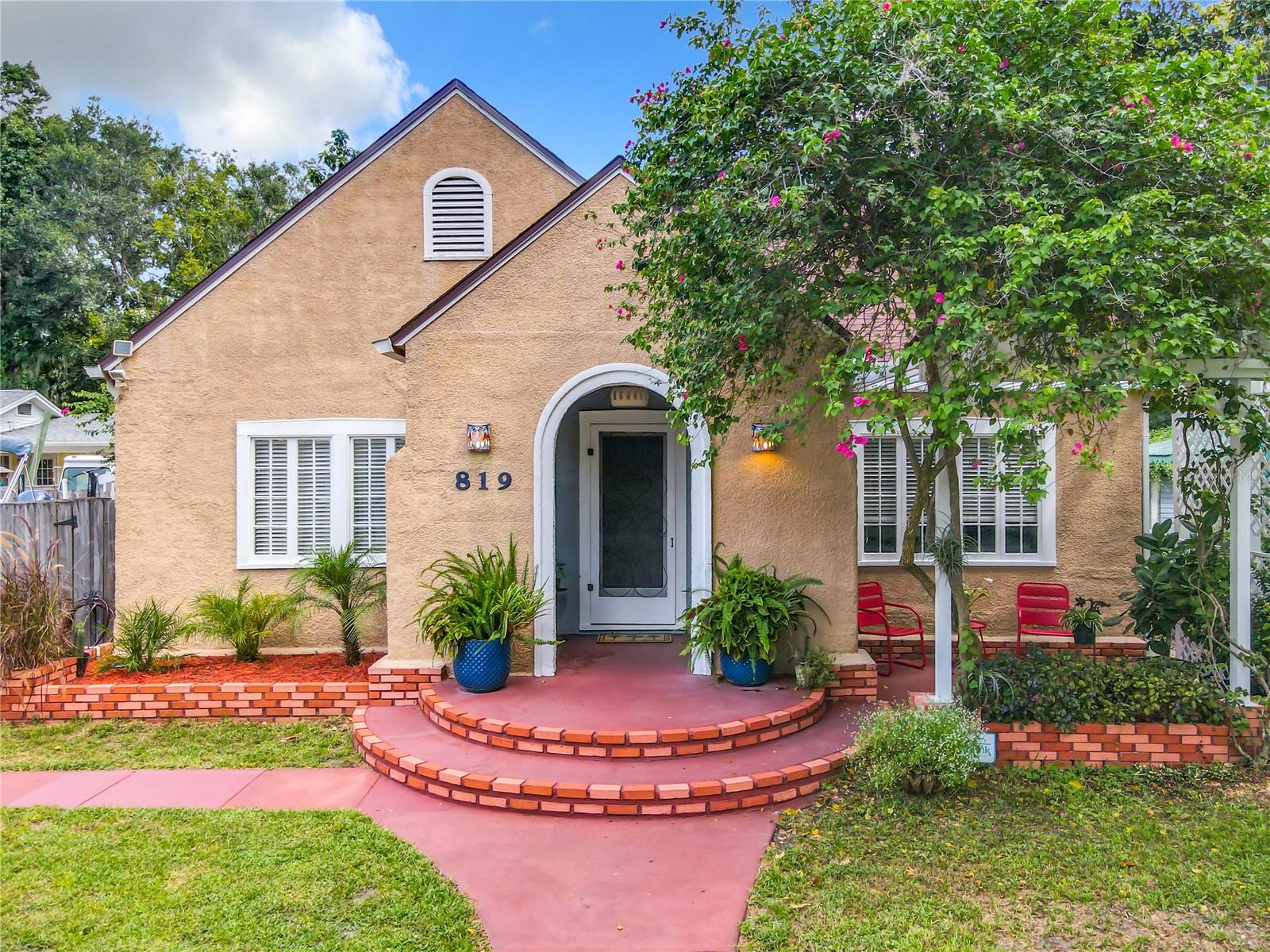 This Spectacular Spanish-Style 100 Year Old Home In The Highly Sought After City Of New Smyrna Beach Is Absolutely Beautiful!  Walking Up The Walkway You Will Find One Of Many Charming Features Of This Home- The Cozy Covered Porch And Trellis Patio. You Can Spend Countless Hours Watching The Butterfly Garden In This Peaceful Setting.  As You Step Inside, You Will Instantly Be Captivated By The Stunning Wood Beams That Enhance The Living And Dining Rooms. The Combination Of The Wood Beams, Fireplace, Natural Light And Neutral Color Walls Creates A Warm And Inviting Atmosphere. Another Highlight Of The Home Is The Spacious Eat In Kitchen Boasting Ample Cabinet Space.  Walking Down The Hallway You Will Find The 3 Bedrooms. All Are Light And Bright And Tastefully Decorated. Bathroom Has Been Recently Updated With A More Modern Vanity, And Jetted Tub. If You Are Someone Who Enjoys Spending Time Outdoors, The Back Yard Is A Garden’s Paradise Featuring A Variety Of Plants And Trees(Lime, Banana And Olive To Name A Few) And The Covered Deck Will Quickly Become Your Favorite Spot. Whether It’s Sunny Or Raining You Can Sit Outside And Be Fully Protected From The Elements. It’s The Perfect Location To Sit And Watch the Birds And Butterflies. Large Shed/Workshop Perfect For The Hobbyist, Woodworker, etc.  Not A Thing Needs To Be Done To This Move In Ready Home. All The Big Ticket Items Have Been Updated-Roof(2023), Tankless Hot Water Heater(2019), Updated Electrical(2019), Updated Most Plumbing(2019), AC (2015). Termite Bond With Massey. All Appliances Will Stay With Home, Making It Move-In Ready For The Next Owners. Oh And Great Storage/Closet Space For An Older Home too! Great Location! Minutes Away From The Spectacular New Smyrna Beach, Popular Flagler Avenue, Medical Facilities, And Amazing Restaurants! Walking Distance To Myrtle Avenue Park! Call For A Showing Today! This Is A Great Opportunity To Own This Exquisite Home With Plenty Of Charm And Character!