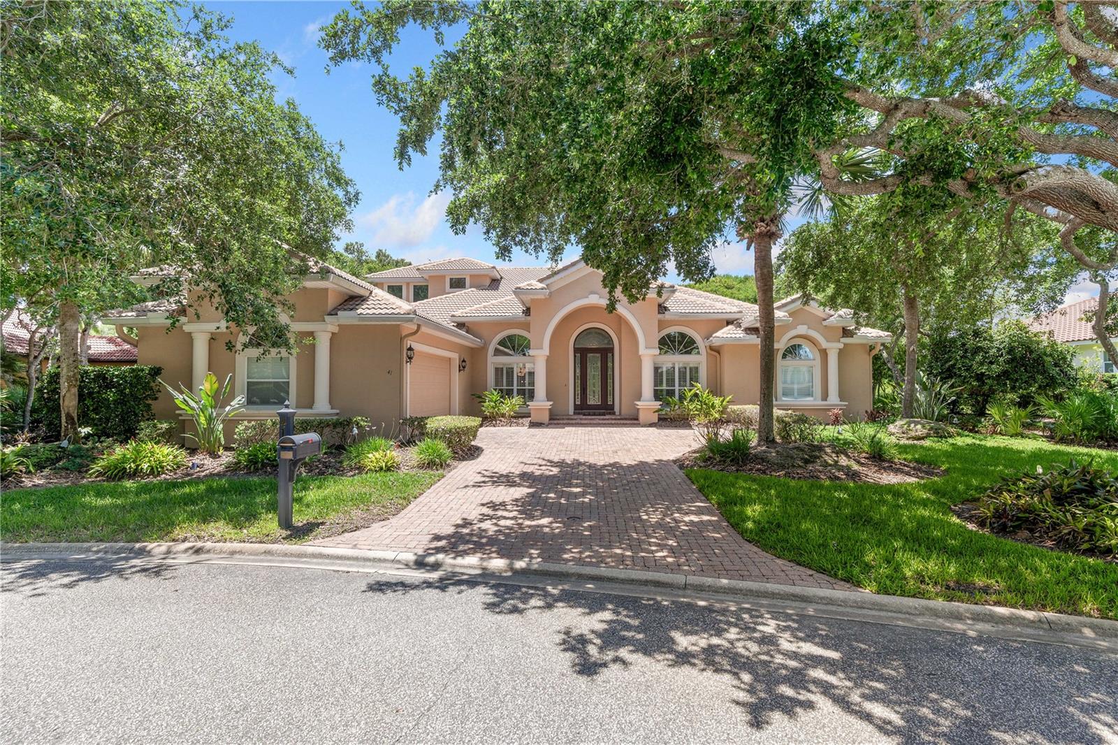 Experience exceptional coastal luxury in this stunning 3-bedroom, 3 full bath, 2 half bath residence located within the highly sought-after Ocean Hammock community of Palm Coast. Thoughtfully designed to blend elegance, comfort, and functionality, this expansive home offers an impressive layout ideal for both refined everyday living and unforgettable entertaining. From the moment you enter, sophisticated finishes, spacious interiors, and an abundance of natural light create an inviting yet elevated atmosphere. Multiple living and gathering spaces provide flexibility for entertaining, relaxing, or creating the ideal private office, media room, or flex space to suit your lifestyle. The thoughtfully designed floor plan balances openness with privacy, featuring generously sized bedrooms and beautifully appointed baths throughout. At the heart of the home, indoor and outdoor living come together seamlessly as oversized doors open to a spectacular covered pool enclosure designed for year-round enjoyment. Whether spending quiet mornings poolside, hosting evening gatherings, or simply enjoying the peaceful surroundings, this private outdoor retreat offers the quintessential Florida lifestyle. Covered lounging areas provide shade and comfort while maintaining an effortless sense of luxury. Perfectly positioned near pristine beaches, championship golf, scenic walking and biking paths, and an array of dining and lifestyle amenities, this extraordinary property offers the rare opportunity to experience the very best of coastal living within one of Palm Coast's most desirable gated communities. Combining space, sophistication, and resort-inspired living, this exceptional home is truly a place to enjoy for years to come.