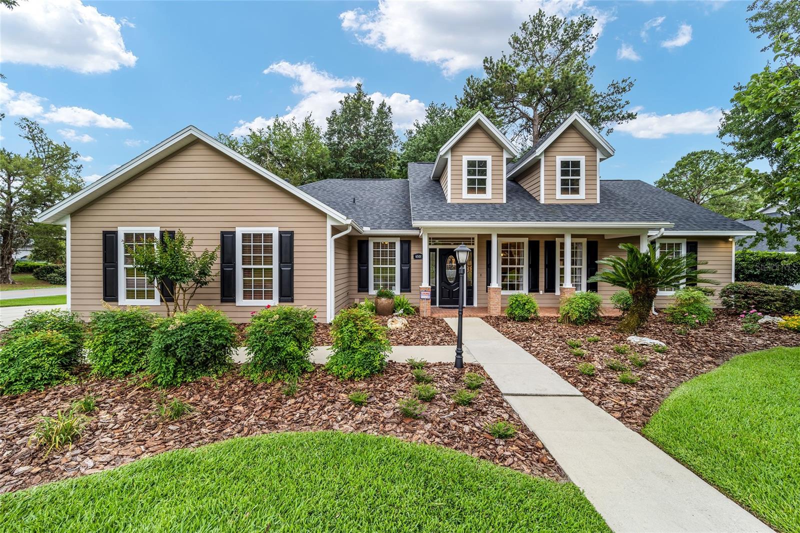 Beautifully maintained by the original owner and truly move-in ready, this exceptional 3-bedroom, 3-bath home is located in the golf course community of Turkey Creek in Alachua. Situated on a large .36-acre corner lot, the home offers more than 1,900 square feet of thoughtfully designed living space with timeless finishes, functional design, and pride of ownership evident throughout. One of the home’s standout features is its functional and flexible layout, with two bedrooms offering private en-suite bathrooms and a third full bath conveniently located for guests and the remaining bedroom—perfect for added comfort and privacy throughout the home. Inside, you’ll find an inviting open layout filled with natural light, cathedral ceilings in the living room, crown molding throughout, and durable wood and tile flooring throughout the home. The spacious living area features custom built-ins and a cozy gas fireplace, creating the perfect space for both relaxing and entertaining. The kitchen is beautifully appointed with quartz countertops, 42-inch cabinetry, stainless appliances and a seamless flow into the dining and living spaces. The split-bedroom floor plan provides privacy, while the generously sized primary suite features a tray ceiling, separate shower and jetted tub, and his-and-hers walk-in closets. Additional features include a large laundry room with sink and built-in storage, oversized side-entry two-car garage with built-in storage, and an expansive driveway with plenty of parking space. Step outside to enjoy the screened porch and brick patio overlooking the privacy-fenced backyard with beautifully maintained landscaping and irrigation system—perfect for peaceful mornings or relaxing evenings outdoors. Updates provide added peace of mind, including a 2022 roof. Residents of Turkey Creek enjoy a golf course, clubhouse, community pool, tennis courts, playground, and scenic walking areas—all conveniently located near I-75, Gainesville, UF, UF Health, and local shopping and dining. This home offers the perfect blend of comfort, quality, privacy, and community living.