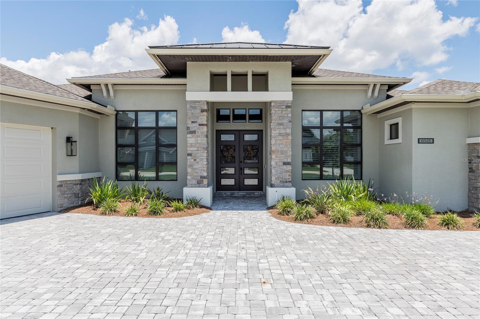 Located in the gated community of Emerald Oaks within Hallam Preserve, this 3-bedroom, 3-bath custom home built by Duane McQuillen, offers 3,160 square feet of thoughtfully designed living space and a 3-car garage with epoxy flooring, built-in cabinetry, refrigerator and bike storage. The open floor plan features crown molding throughout, tile and LVP flooring, custom built-ins, a wet bar with wine cooler, mud bench, and pantry with built-in shelving. Bonus/media room provides additional living space for movie nights, gaming, or entertaining. The flex room located just inside the garage entry offers versatility as a fitness room, hobby space, second office, or additional storage area. Pocketing sliding glass doors open to the outdoor living area, where you'll find two separate lanais, including a screened lanai with an outdoor kitchen, creating multiple spaces for entertaining and relaxing. The backyard features a pavered sitting area with a fountain, custom fire pit gathering space, landscape uplighting and downlighting, and open views with additional separation from neighboring homes. Washer and gas dryer convey. Remaining building materials stored in the attic will also convey. Hallam Preserve offers a community park, pool and clubhouse.
Conveniently located near the Polk Parkway, shopping, dining, and medical facilities.