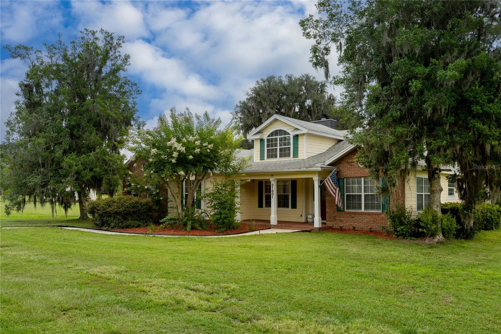 Welcome to this beautifully upgraded 3 bedroom 2 bathroom home on 5 acres with incredible views! This residence offers the perfect blend of comfort, privacy, and convenience. Step inside to discover a thoughtfully designed layout featuring a spacious living room perfect for both entertaining, accented by natural light pouring in through expansive windows. The chef-inspired kitchen features updated appliances, custom cabinets with ample storage, and an eat-in breakfast area for casual dining. Adjacent to the kitchen, a formal dining room provides a refined setting for intimate dinners or festive gatherings. The living area has French doors that lead to a quaint back porch and grilling area, stepping down to a flagstone courtyard with a peaceful sitting area ideal for enjoying morning coffee while watching the sun rise across the field or for evening breezes. Across the home, there are two additional bedrooms and a full bathroom, providing ample accommodation, plush new carpeting, and ample closet space. These additional bedrooms provide versatility for guests. An additional storage area off the oversized mud room, as you enter the side door. Retreat to the expansive primary suite featuring a walk-in closet and an ensuite bathroom with a double vanity sink, jacuzzi tub, and tiled stand-up shower. Outside, revel in the beauty of a 5-acre lot with a fire pit area, garden, chicken coop, an extra storage shed, and a majestic Grand Daddy Oak with a rope swing. Recent upgrades include a new roof (2023), a new A/C system (2024), a new well (2025), a new septic (2021), and a tankless water heater (2024). The home has also had the front and back fully landscaped, the interior painted, including baseboards and trim, and new appliances installed. Great location close to I-75, downtown Alachua, Gainesville, and High Springs. Plenty of recreation with the river and springs minutes away. Schedule your showing today and make this exceptional residence your new home!