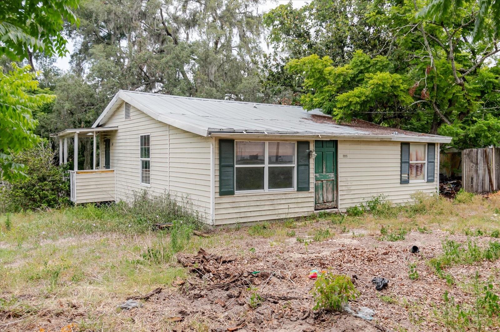 Calling all investors, contractors, and handy buyers — here's your next project! This 2-bedroom, 1-bath home sits on a spacious, high and dry half-acre lot in Dade City, surrounded by mature oaks and tons of privacy. The lot alone is worth a look: cleared front yard, room to park equipment or boats/RVs, and no wetlands or low spots to worry about.
The home needs a full renovation — interior is gutted in places and ready for your design, plumbing and electrical will need updating, and the kitchen and bath are a blank slate. Metal roof is in place. This is a true as-is, cash or hard-money opportunity — priced to move and built for someone ready to add value fast.
Whether you're looking to flip, hold as a rental, or build some sweat equity into your own homestead, this property has the space and bones to make it happen. Bring your contractor and your vision — properties with a half acre this close to Dade City don't come around often.