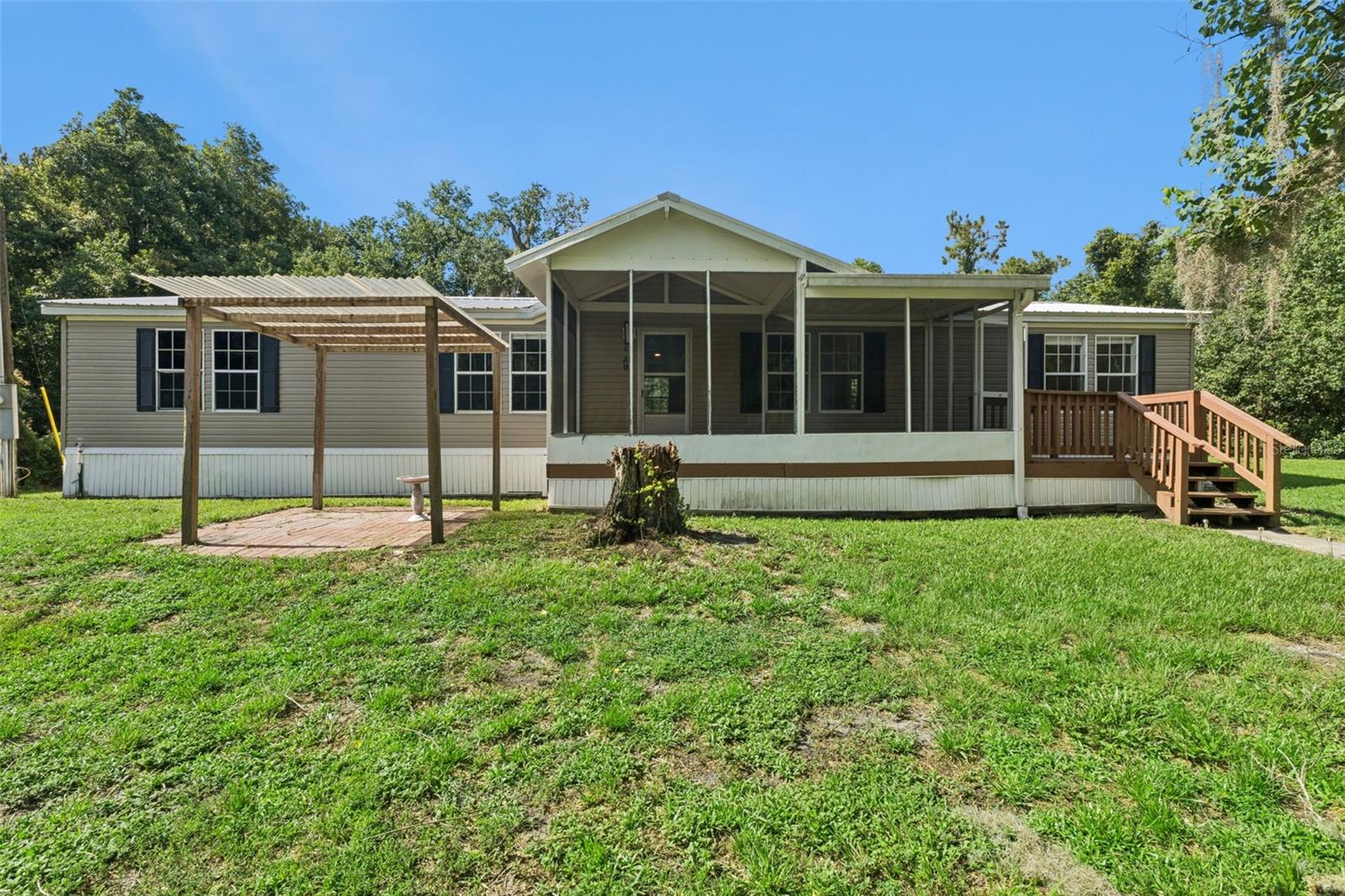 COUNTRY LIVING WITH MODERN UPDATES ON ALMOST AN ACRE!
Welcome home to this beautifully maintained 3-bedroom, 2-bath Redman manufactured home nestled on .92
acres in the peaceful community of Satsuma. Offering 1,728 square feet of living space, this home
combines comfort, functionality, and room to enjoy the outdoors.
Step inside to discover a spacious, open floor plan featuring new luxury vinyl plank flooring, a warm
wood-burning fireplace, and abundant natural light. The kitchen comes fully equipped with all
appliances, and the washer and dryer are included, making this home truly move-in ready.
You'll appreciate the many recent improvements, including a new roof (2019), water heater (2023), and
new insulation and vapor barrier beneath the home, providing added comfort and peace of mind.
Relax on the screened porch, entertain on the decks, or enjoy the privacy of the partially fenced yard
with nearly an acre to make your own. Zoned AG/Rural Residential, there's plenty of room for your boat,
RV, garden, or outdoor hobbies—all with NO HOA telling you what you can do.
Located in Flood Zone X, flood insurance is typically not required by lenders. Whether you're looking
for your first home, a quiet country retreat, or simply more space to spread out, this property offers
the perfect opportunity to enjoy Florida living at its best.