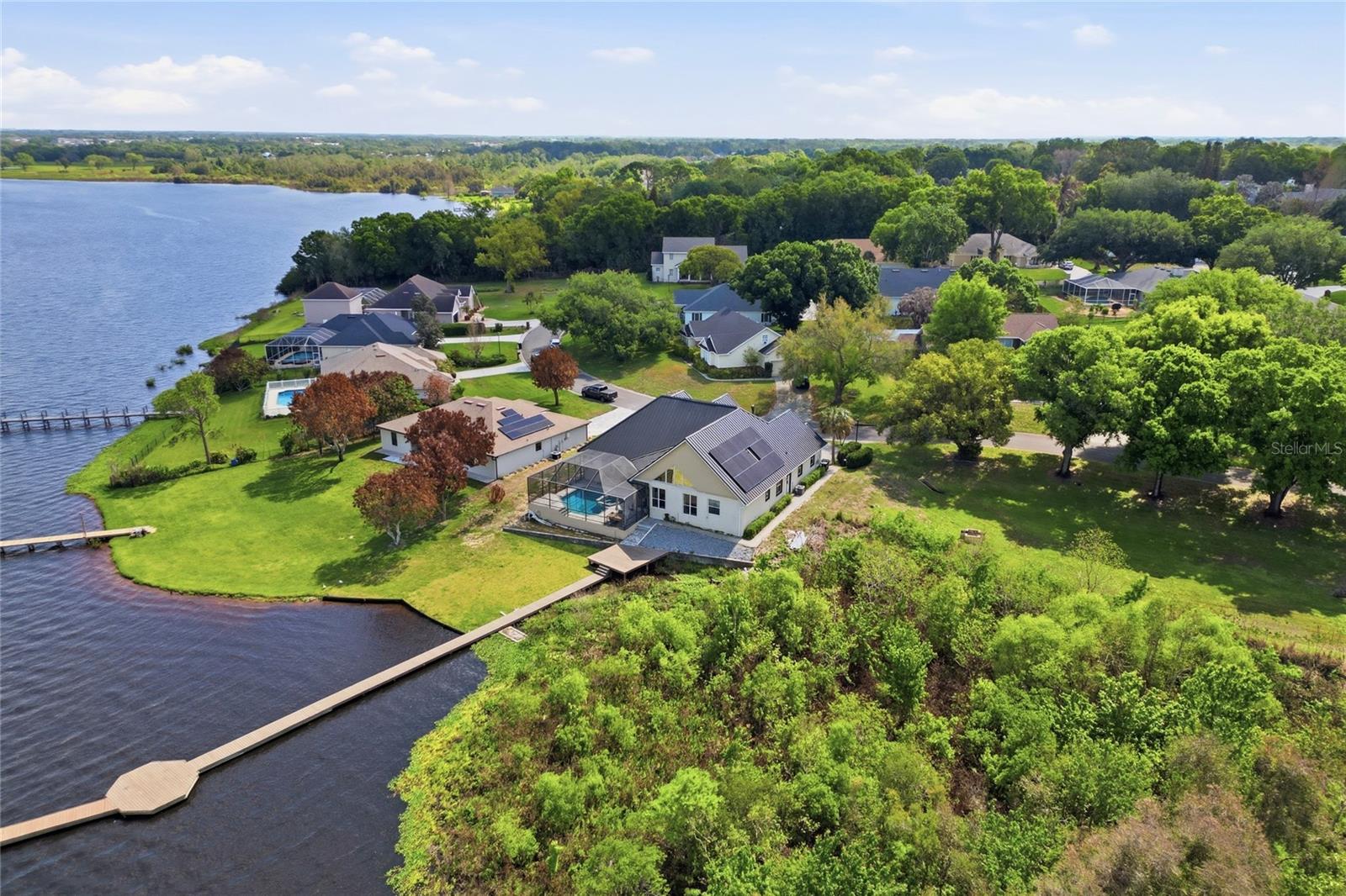Welcome to your slice of LAKEFRONT, LAKE VIEW, POOL HOME paradise on the pristine shores of Lake Mariam in Winter Haven, Florida. This stunning 3-bedroom, 2.5-bathroom home with a versatile BONUS ROOM offers the ultimate Florida lifestyle, complete with direct lake access, a private  dock, and breathtaking water views right from your own backyard.

Built to last and designed for low maintenance, this home features a durable METAL ROOF and solar panels, offering peace of mind and significant savings on energy costs year after year. Whether you’re sipping morning coffee while watching the sunrise over Lake Mariam or heading out for a day on the water, this property delivers the lakefront living experience you’ve been searching for.

Inside, the thoughtfully designed floor plan offers three comfortable bedrooms, two and a half bathrooms, and a spacious bonus room perfect for a home office, media room, guest suite, or playroom. The heart of the home is the beautifully designed kitchen, featuring abundant cabinetry, stainless steel appliances, granite countertops, a center island, breakfast bar seating, glass-front upper cabinets, recessed lighting, and an open layout that flows seamlessly into the main living areas. With its generous workspace and water views from the adjoining living space, this kitchen is ideal for both everyday living and entertaining.

The oversized 2-car garage provides ample storage for vehicles, watercraft equipment, and all your lake toys. Step outside and discover what truly sets this property apart: your own private HEATED POOL and SPA, along with an impressive  private dock stretching out over the serene waters of Lake Mariam, ideal for boating, fishing, kayaking, or simply soaking in the natural Florida scenery. With direct lake access and one of the longest docks on the water, this is a rare find in today’s market.

Located in Winter Haven’s sought-after lake corridor, you’re just minutes from dining, shopping, Legoland Florida, and easy access to I-4 connecting you to both Tampa and Orlando. Schedule your showing today!