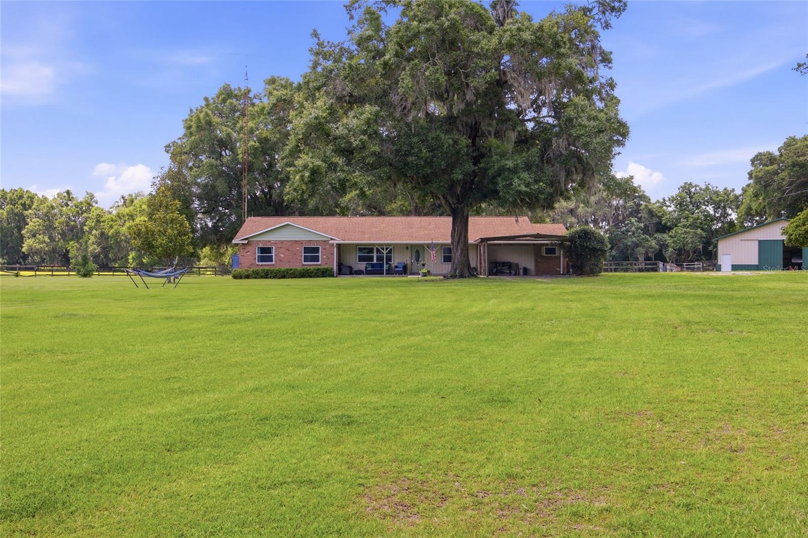 Welcome to this exceptional 10.44-acre farm located in beautiful Marion County, Florida — proudly known as the Horse Capital of the World® — offering the perfect blend of country living and modern convenience. Designed with equestrian enthusiasts in mind, the property features a well-equipped 8-stall horse barn complete with a private office featuring its own A/C and Wi-Fi, along with a dedicated tack and feed room. A separate 2,226 sq ft metal building provides excellent versatility with ample space for storage, workshop use, equipment parking, or drive-through access.

The spacious 3,730 sq ft home offers 5 bedrooms, including a potential flex space or private mother-in-law suite with its own entrance. The home has been beautifully updated with a fully remodeled kitchen and all three bathrooms renovated. The kitchen showcases stone countertops, abundant cabinetry, and generous storage throughout.

Adding to the property's value and peace of mind, the home features a new roof installed in 2019, a new hot water heater in 2023, a recently completed 4-point inspection, and a current wind mitigation report. The property has also been appraised above the current listing price at $860,000, providing added confidence for prospective buyers. Truly move-in ready, this farm is prepared to welcome its next family.

Enjoy stunning grassy pastures and peaceful farm views while remaining conveniently located less than 20 minutes from the World Equestrian Center. Experience the tranquility of country living without sacrificing easy access to shopping, dining, medical facilities, and all the conveniences that make Marion County one of Florida's most desirable places to call home.