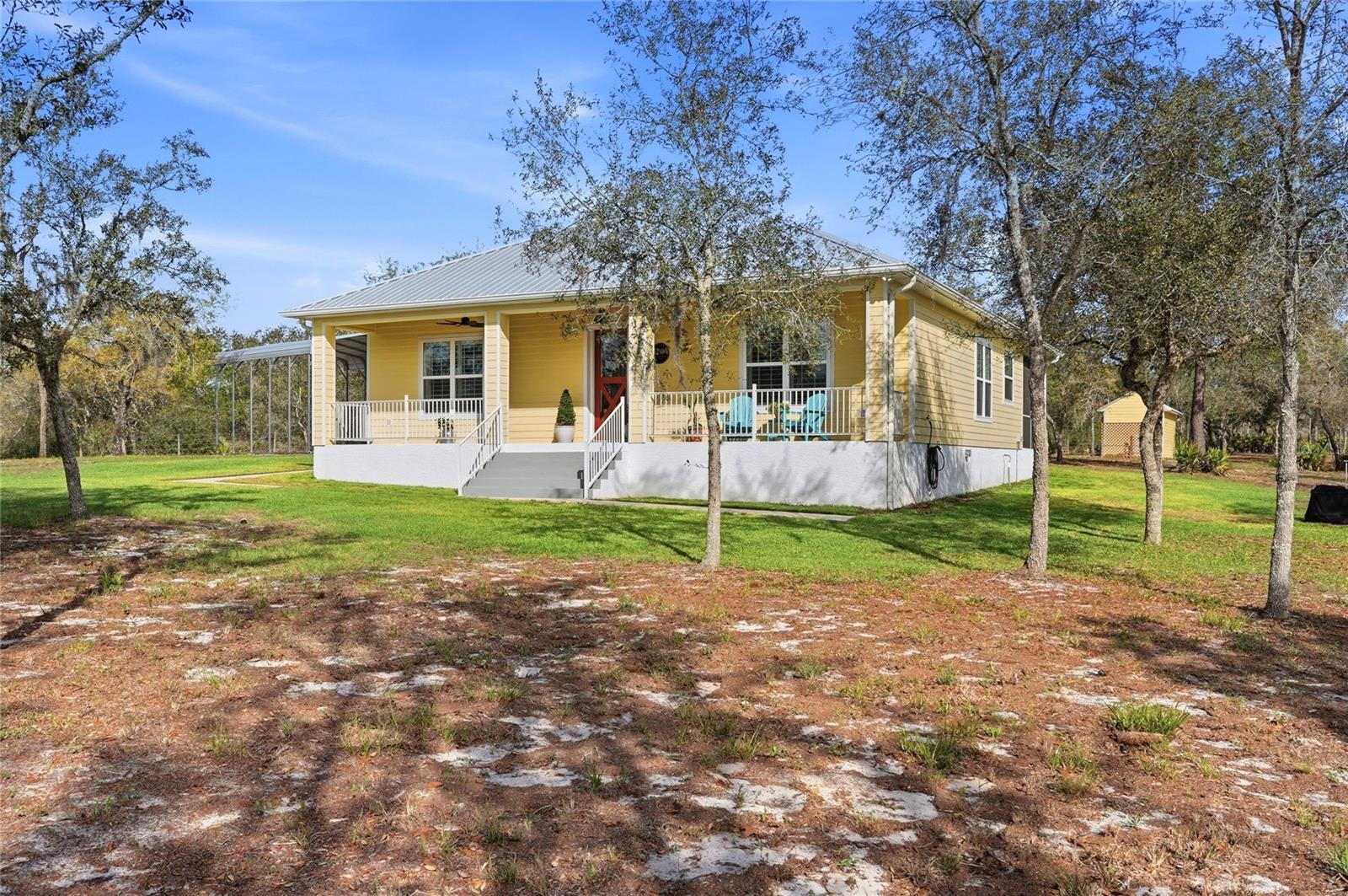 A True Escape Into Old Florida. Tucked deep within the (gated wildlife sanctuary) of Blue Jordan Forest, this remarkable (2.86-acre) corner property offers a lifestyle that feels worlds away from the noise, pressure, and pace of everyday life. Surrounded by protected land and untouched natural beauty, this is more than a home. It is a private retreat where peace, privacy, and nature take center stage. Set within a designated wildlife preserve, the setting is unforgettable. Bald (eagles) soar overhead, (deer) wander freely, and the sounds of cranes and native birds replace traffic and city noise. The (fully fenced) and gated homesite is carefully preserved with native scrub brush oaks and Georgia pines, creating a secluded atmosphere that feels both wild and welcoming. A private entrance and irrigation around the home add comfort and function while preserving the natural character of the land. Built in (2021), the custom residence was designed for durability, efficiency, and easy living. Construction includes concrete block filled with concrete and foam insulation, Hardie board siding, and a steel roof with spray foam insulation. The result is a home that is both strong and energy efficient, with electric costs averaging approximately $120 per month. Inside, the home offers an inviting open-concept design with 10-foot ceilings and tile flooring throughout, including the porches. The living spaces are comfortable, open, and easy to enjoy, whether you are hosting guests or simply savoring the quiet. The kitchen is beautifully appointed with granite countertops, custom cabinetry, a gas cooktop with stainless hood, double ovens, and Bosch stainless appliances. The primary suite is a peaceful hideaway with French doors to the screened porch, a spacious walk-in closet, and a well-finished bath with dual vanities and a walk-in shower. The guest bedroom is generously sized, also featuring a walk-in closet and easy access to a full bath. Outdoor living is where this property truly sets itself apart. The screened rear porch and custom outdoor cooking area with stainless hood vent, water connections, and Blackstone griddle create the perfect place to unwind, entertain, and fully take in the stillness of the surrounding preserve. Additional features include a (13kW) backup generator, (Starlink high-speed internet), underground utilities, a custom (8x20) utility building that matches the home, and a (20x24) steel carport with 14-foot clearance. Blue Jordan Forest is a rare, conservation-minded community of large acreage homesites, winding roads, and preserved landscapes. Life here is intentionally different. Ride ATVs or golf carts, plant a garden, explore the trails, and enjoy the kind of freedom and space that is becoming harder to find. Just beyond the gates, Frostproof offers a laid-back small-town setting between Lake Clinch and Lake Reedy. Nearby, the Lake Wales Ridge State Forest and Walk-In-The-Water Wildlife Management Area offer thousands of acres for hiking, camping, fishing, and exploring.
For the buyer craving privacy, quiet, and a place to truly disconnect, this property offers something rare in Florida: a genuine refuge from the world.