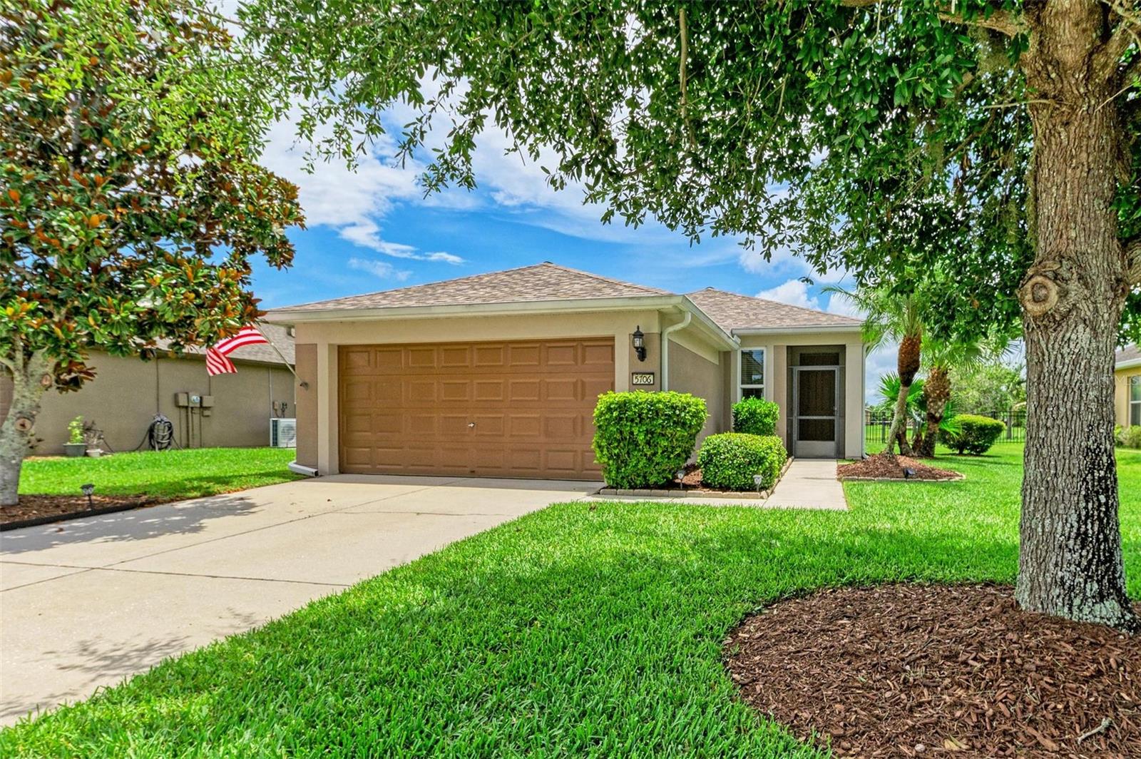 Welcome to this beautifully maintained 3-bedroom, 2-bathroom home in the highly desirable Harrison Ranch community, where thoughtful upgrades, stunning water views, and resort-style amenities come together to create the perfect Florida lifestyle. From the moment you arrive, you'll be impressed by the meticulous landscaping, screened front entryway, and newer roof installed in 2022 with waterproof underlayment. Step inside to discover a bright, open floor plan filled with natural light and designed for both everyday living and entertaining. Tile flooring flows throughout the main living areas, while engineered hardwood flooring adds warmth and elegance to the bedrooms. The spacious kitchen features stainless steel appliances, abundant cabinetry, and a cozy eat-in dining area. The laundry room offers added convenience with soft-close maple wood cabinetry for extra storage and organization. The private owner's suite offers serene pond views, a walk-in closet, and an ensuite bathroom designed for comfort and functionality. Step outside to your screened lanai and extended paver patio, the perfect setting for outdoor dining, grilling, or gathering around a fire pit while enjoying breathtaking pond views and the abundant wildlife and birds that frequent the area. The fully fenced backyard provides peace of mind for pets and family members. This home is loaded with valuable updates and features, including hurricane-impact windows with lifetime protection, a new AC system installed in 2020 with the main board and motor replaced in 2025, fresh interior paint, whole-home surge and lightning protection, epoxy-coated garage flooring, gutters, hurricane shutters, and an irrigation system. Living in Harrison Ranch means enjoying an unmatched amenity package, including a 24-hour fitness center, heated Junior Olympic-sized pool, tennis courts, basketball and pickleball courts, 5.5 miles of scenic nature trails, and an activities director who organizes events and activities for residents of all ages. Conveniently located with easy access to Tampa, St. Petersburg, and Sarasota—all within approximately 45 minutes—this home offers the perfect balance of tranquility and accessibility. Whether you're sipping your morning coffee overlooking the water, taking advantage of the community amenities, or entertaining friends and family on your expansive patio, this exceptional home truly checks every box for easy Florida living.