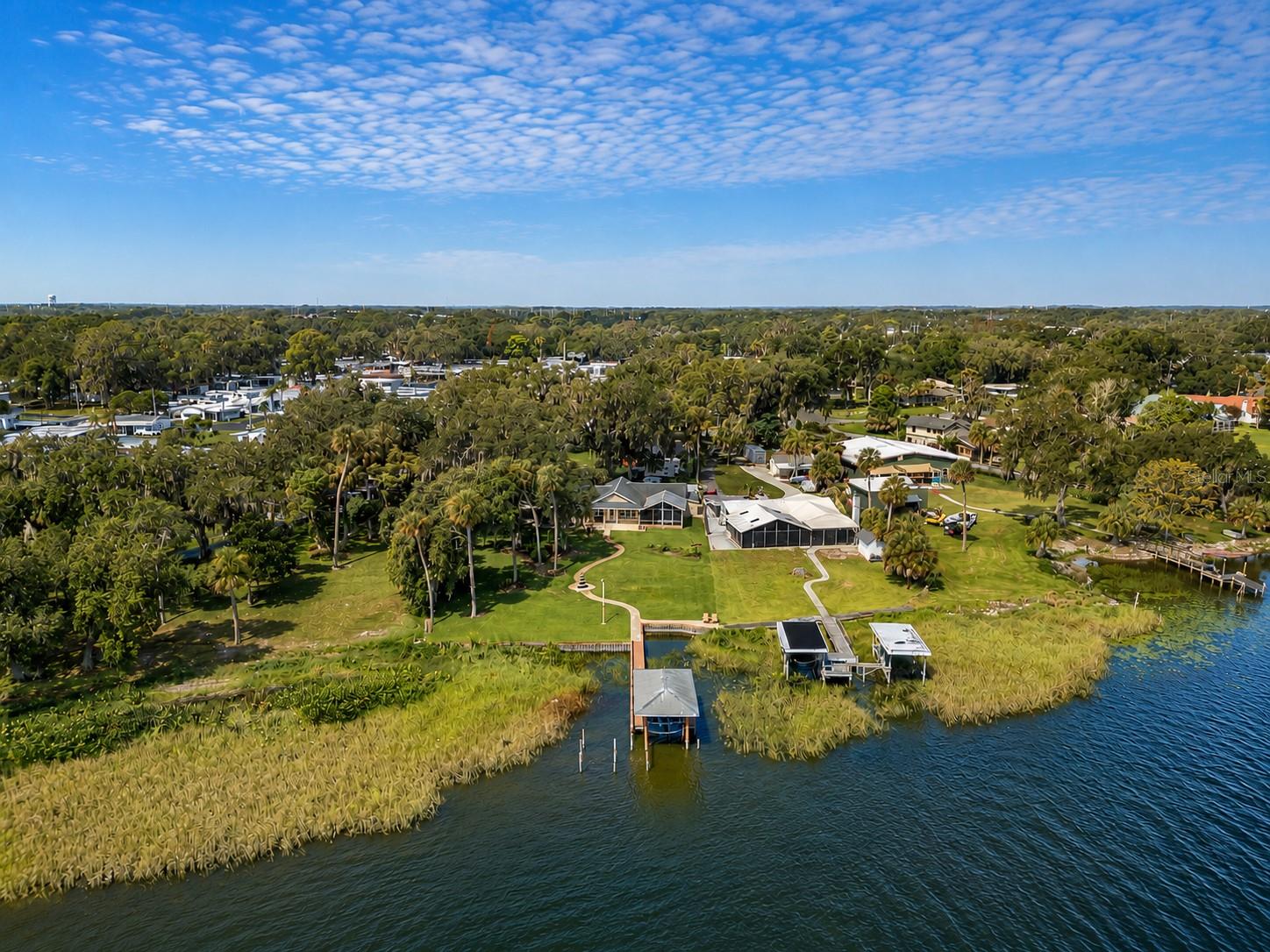 Luxury Waterfront Living on the Harris Chain of Lakes – Completely Renovated!

Experience the perfect blend of modern luxury and Florida waterfront living at 606 N Shore Dr. Nestled on the shores of Lake Griffin, one of the most sought-after lakes in the renowned Harris Chain of Lakes, this beautifully renovated home offers direct access to one of Central Florida’s premier boating and fishing destinations. Cruise through the interconnected chain of lakes, visit waterfront restaurants by boat, enjoy world-class bass fishing, explore the scenic Ocklawaha River, or simply spend the day surrounded by abundant wildlife and breathtaking natural beauty.

From the moment you arrive, majestic oak trees and panoramic lake views create an unforgettable first impression. Inside, you’ll immediately appreciate the extensive renovations completed to a high standard, creating a home that is truly move-in ready.

At the heart of the home is the spectacular fully remodeled oversized kitchen, thoughtfully designed with abundant cabinetry, premium finishes, generous countertop space, and an open layout ideal for entertaining family and friends. Whether preparing everyday meals or hosting large gatherings, this kitchen is sure to impress.

The spacious primary suite serves as a private retreat with beautiful lake views and direct access to the expansive screened lanai. The completely renovated primary bathroom offers a true spa-like experience featuring an oversized rain shower with multiple body jets, a smart toilet, and elegant designer finishes. The guest bathroom has also been fully renovated, completing the home’s fresh, contemporary feel.

The thoughtfully designed floor plan offers multiple living and entertaining spaces that flow effortlessly together while maximizing natural light and showcasing beautiful lake views from the main living areas.

Large windows frame the water, while the impressive 23’ x 20’ screened lanai extends your living space outdoors. Whether you’re enjoying your morning coffee, entertaining guests, or simply relaxing after a day on the water, you’ll be treated to some of the most breathtaking sunsets Lake Griffin has to offer.

Step outside to your private waterfront where a seawall, dock, and covered boat lift provide easy access to the Harris Chain for boating, fishing, kayaking, paddleboarding, or sunset cruises. Two additional storage sheds offer plenty of room for fishing gear, tools, and outdoor equipment.

Located just minutes from historic downtown Leesburg, you’ll enjoy convenient access to Venetian Gardens, waterfront parks, restaurants, shopping, golf courses, medical facilities, and year-round events, while still enjoying the peace and privacy of lakefront living.

The Harris Chain of Lakes offers endless opportunities for boating, fishing, waterfront dining, and exploring one of Central Florida’s premier freshwater destinations.

Wake up to peaceful lake views, spend your afternoons on the water, and end every evening watching spectacular sunsets over Lake Griffin. Fully renovated and move-in ready, this exceptional waterfront home offers the perfect combination of luxury, comfort, and an unforgettable Florida lifestyle. Schedule your private showing today!