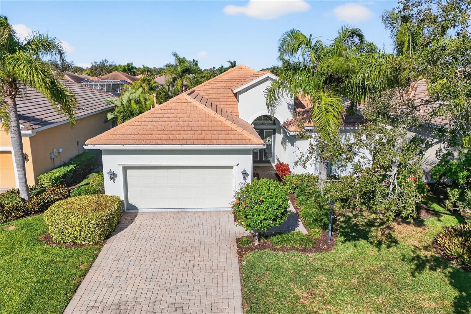 INCREDIBLE VALUE IN THIS TURNKEY FURNISHED MOVE IN READY HOME IN WISTERIA PARK!!! Welcome to this exceptional Neal-built residence where timeless design meets effortless Florida living. This beautifully maintained three bedroom plus office, two and a half bathroom home is truly move-in ready—just bring your suitcase and start enjoying the lifestyle. From the moment you arrive, the home’s inviting curb appeal, manicured landscaping, and welcoming entry set the tone. Inside, soaring ceilings, abundant natural light, and an open, flowing floor plan create an atmosphere that is both elegant and comfortable, ideal for everyday living and entertaining alike. The heart of the home features a spacious great room with tray ceilings and expansive sliding glass doors that open seamlessly to the outdoor living area. The kitchen is thoughtfully designed with solid wood cabinetry, granite countertops, stainless steel appliances, a gas cooktop, and generous counter space, all opening to the dining and living areas—perfect for hosting gatherings. The primary suite offers a peaceful retreat with ample space, tranquil views, and direct access to the lanai. The ensuite bath is spa-inspired, featuring dual vanities, a soaking tub, a walk-in shower, and refined finishes that create a relaxing sanctuary.
Step outside to the private screened lanai, where a sparkling pool and serene lake views provide the perfect backdrop for morning coffee, evening cocktails, or simply unwinding. This outdoor space is designed to be enjoyed year-round and offers the privacy and tranquility that define the Florida lifestyle. Additional highlights include turnkey furnishings for immediate enjoyment, high ceilings with crown molding, multiple living and dining spaces, a private lakefront setting, and a paver driveway and lanai. The home has been meticulously cared for and shows true pride of ownership throughout. Wisteria Park offers a resort-style community atmosphere and is conveniently located near Anna Maria Island, Robinson Preserve, DeSoto National Memorial, shopping, dining, and medical facilities—providing an ideal balance of peaceful living and easy access to local amenities. This is more than a home; it is a lifestyle opportunity. Properties of this quality, condition, and turnkey convenience are rare. Schedule your private showing today and experience the best of Wisteria Park living