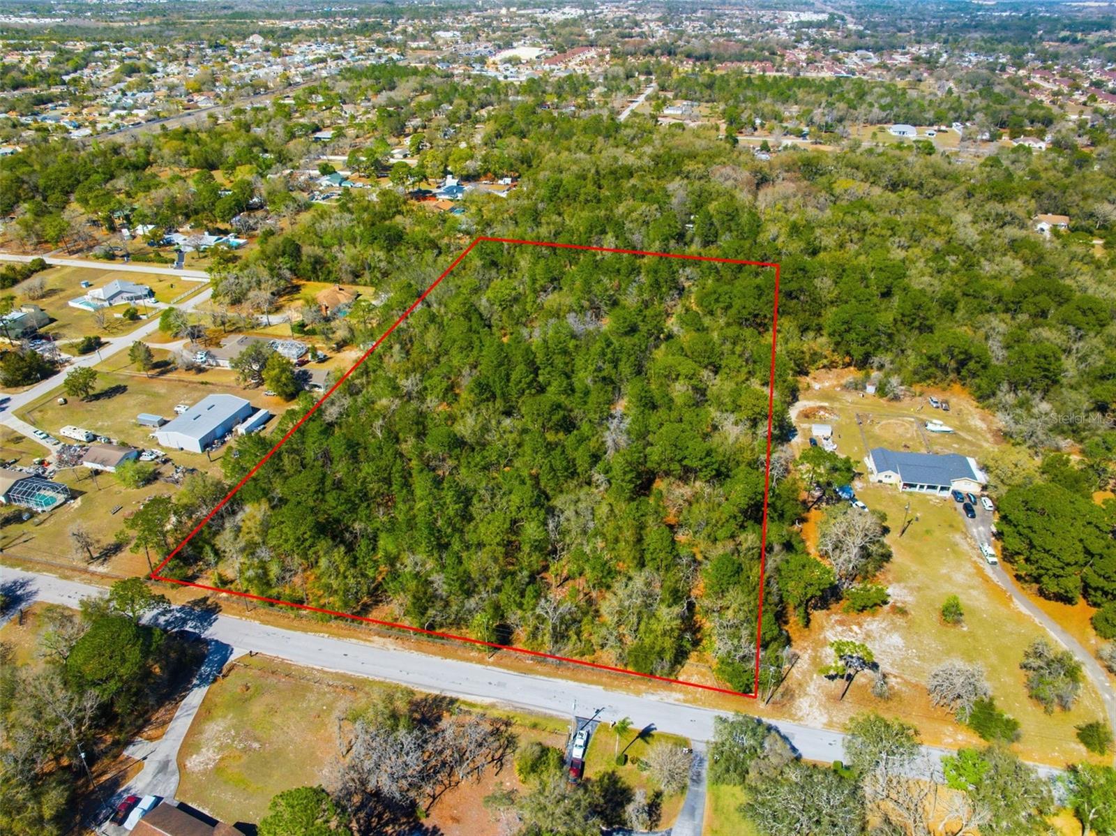 Welcome to the world of opportunity. This rare 10-acre parcel offers privacy, flexibility, and future potential. Fully fenced, high and dry, and featuring partially cleared trails throughout, this property is ready for your imagination whether you're envisioning a private estate, multi-generational compound, agricultural use, or future development opportunity.
Located in the E-R Estate-Residential District, the property allows for single-family detached dwellings with a minimum of one acre per home and a maximum density of one dwelling per acre creating the potential for up to 10 homes under current zoning. Rezoning or a master planned development approach may allow for increased density, potentially up to 22 total units, subject to county approval. In addition to residential use, the zoning district also permits public schools offering additional flexibility for institutional or educational development opportunities.
The E-R zoning district is intended as a transitional area between agricultural and suburban development, supporting estate-style living, limited agricultural activities, and livestock in accordance with county guidelines making this ideal for buyers seeking space, privacy, and versatility.
Nestled on a quiet dead-end street near Fivay High School, this property offers both seclusion and convenience in an area experiencing continued growth and expansion. Public water is available nearby and would require approximately 1,000 feet for connection.
Whether you're a builder, investor, educational institution, or end user looking to create something special, this property offers strong potential in a rapidly growing corridor.