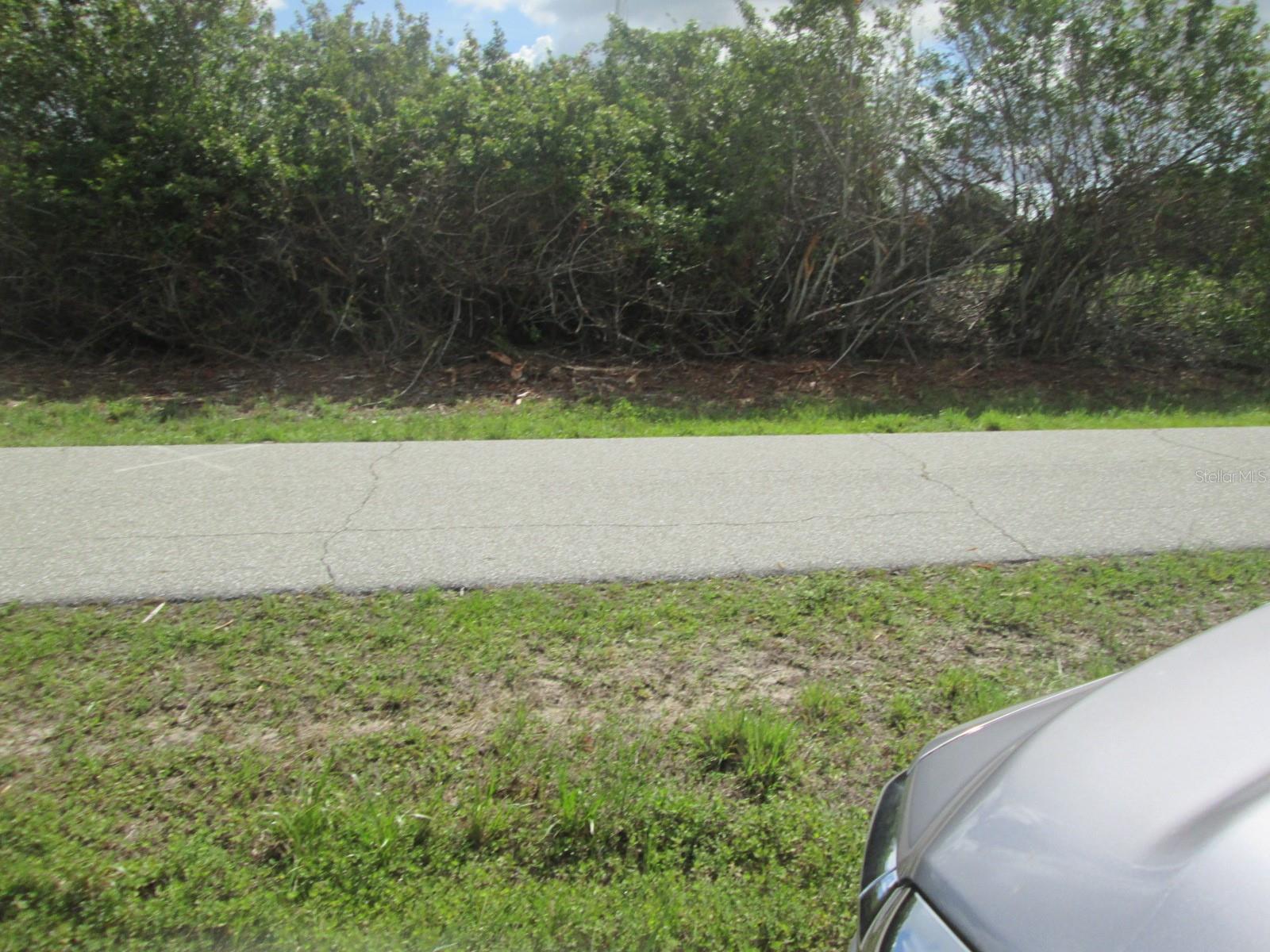 View of a golf course. Two commercial lots to be sold together.    Total 100 on road frontage,  150 each side.
