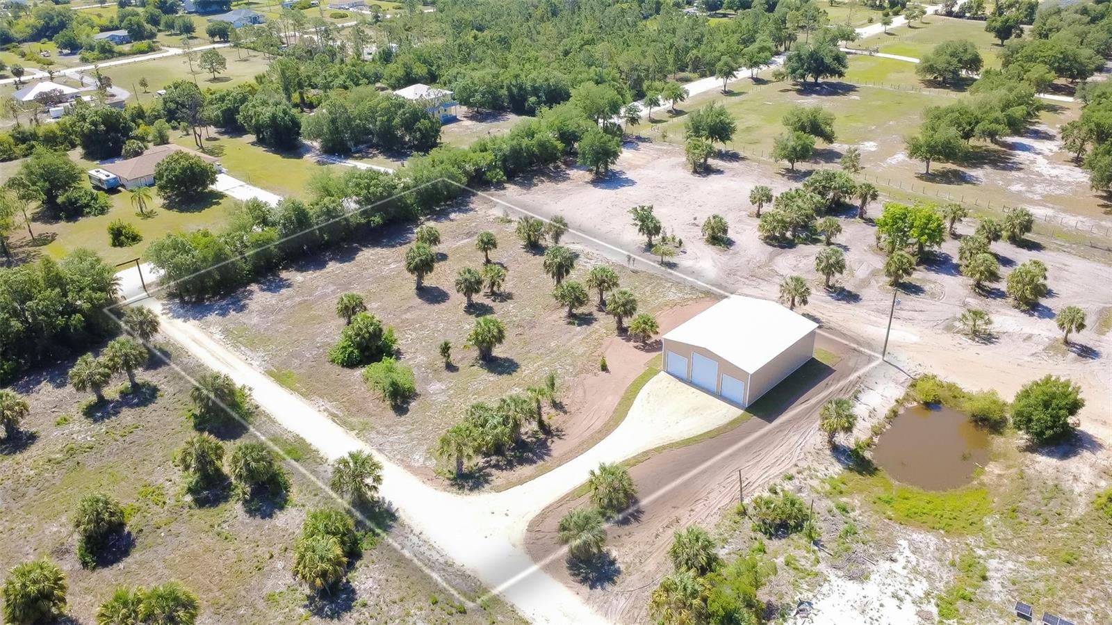 Rare opportunity to own a newly constructed 2,000 sq ft steel building with (1) 12x14 and (2) 10x10 roll up doors on agriculturally zoned land in the desirable Charlotte Ranchettes area of Punta Gorda. This versatile property is well-suited for a variety of uses including equipment storage, workshop space, RV and boat storage, or small business operations. The metal building offers a durable, low-maintenance structure designed for functionality and flexibility, featuring a 200-amp electric service, LED overheading lighting with outlets, and heavy duty steel frame construction! Ideal for contractors, landscapers, hobbyists, or business owners seeking secure space with fewer restrictions than traditional residential zoning. Situated on AG-zoned property, this site allows for a wide range of agricultural and accessory uses. With plenty of space to build your new home or even turn the existing structure into a barndominium. The Charlotte Ranchettes community is known for its larger parcels, privacy, and accessibility, while still being conveniently located near Punta Gorda, US-17, and I-75. No HOA restrictions. Ample space for storage, expansion, or additional improvements. This is a unique opportunity to acquire a functional-use property in a growing Southwest Florida market.