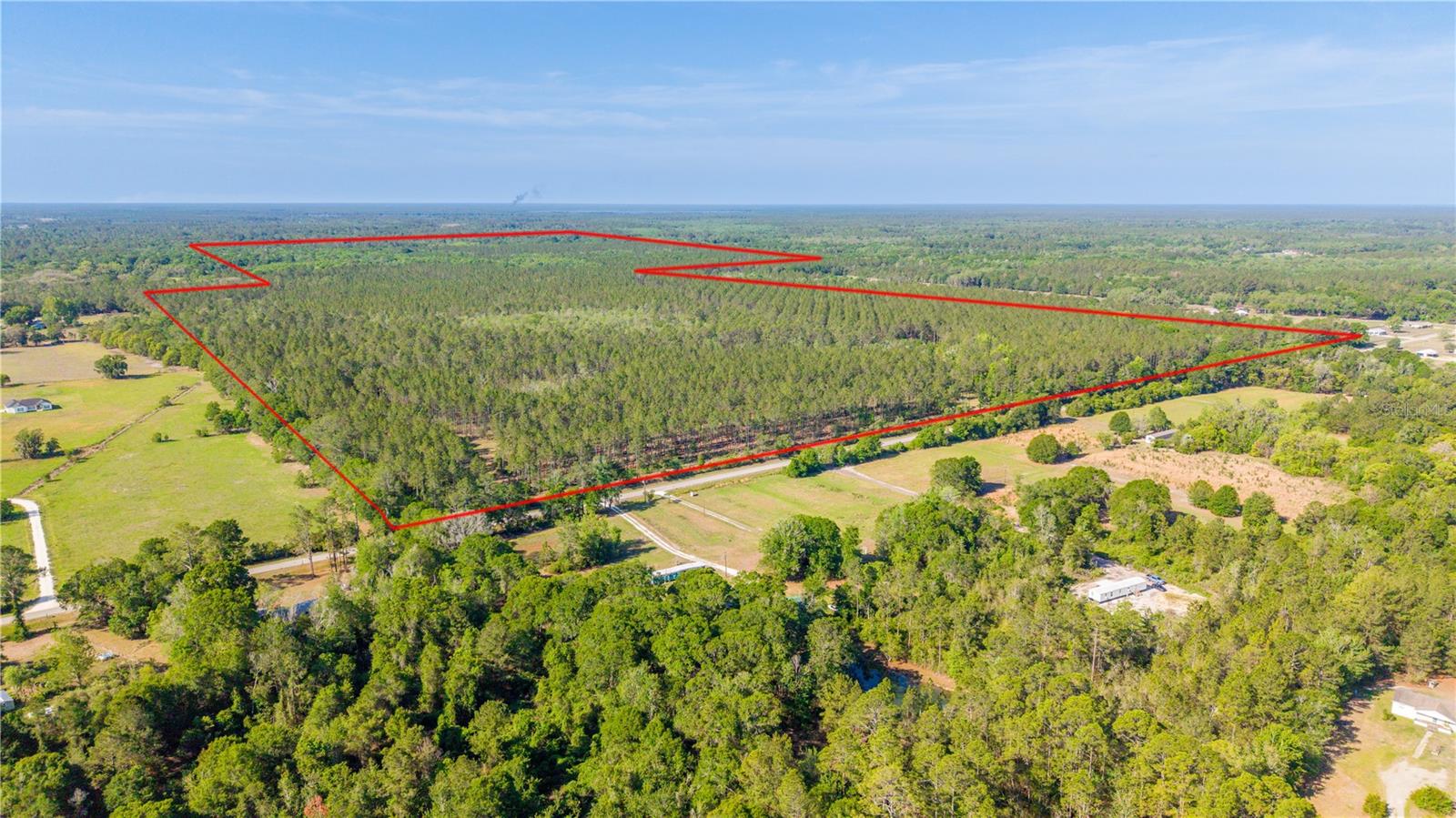 Built for the serious outdoorsman, this 325-acre high-fenced hunting property in Bradford County offers the rare combination of mature timber, prime wildlife habitat, privacy, and infrastructure already in place.
Covered in professionally established 22-year-old planted pines with scattered mixed hardwoods, this property has the habitat and natural cover hunters spend years searching for. The diverse landscape supports healthy populations of deer, turkey, and native wildlife while the absence of wild hogs helps protect both the land and game quality.
A high fence surrounds the perimeter, creating a premier setup for wildlife management, hunting, and long-term recreational use. Internal trails allow easy access throughout the property by truck, ATV, or side-by-side, making it ideal for food plots, stand access, and year-round enjoyment. Unlike raw land requiring years of preparation, this tract already has the essentials in place:
Automatic gated entrance
Existing well
Power on site
Cleared homesite
Dirt house pad ready for your hunting cabin, lodge, or barndominium
Whether you envision a private deer camp, family hunting retreat, income-producing recreational property, or legacy ranch to pass down for generations, this property delivers the true North Florida outdoor lifestyle.
Large, contiguous hunting tracts with mature timber, infrastructure, and high fencing are becoming increasingly difficult to find in today’s market. This is more than land — it’s a turnkey recreational investment designed for hunters, land investors, and outdoor enthusiasts alike.