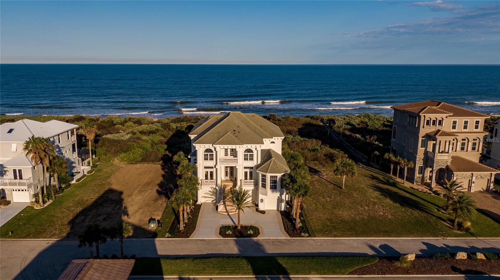 Beyond CAPTIVATING is the best description for this OCEANFRONT coastal mansion situated in the Ocean Hammock community. Just imagine over 10,000 total square feet of pure luxury thats ALL yours to enjoy. As soon as you come up the staircase leading to the grand front entry you step into the opulent and breathtaking views of the beach and ocean from every angle of the open concept living room/ kitchen/sitting area and nook. It feels as if you walked into the scenes of an upscale magazine for Restoration Hardware, Magnolia, Mcgee and Company, Pottery Barn, Anthropologie and more. You take a seat with the triple sliders opened and you are quickly mesmerized by the sights and sounds of water from the fountain cascading into the pool and wave after wave crashing into the sea. Just as you take in all the splendor around you; dreaming about waking up each day with stunning and different sunrises streaming in from the East and the gorgeous sunsets from the West pouring in as a last kiss of the day fill you with aw. With all the opulent detail to all the fixtures and furnishings the home is still gently appointed in way that makes you feel so comfortable you start to imagine yourself jumping into one of the fluffy beds or snuggling on the coach in front of the gas fireplace with a book and your favorite beverage. 
The FULLY RENOVATED home includes 5 bedrooms with ensuites, 6 1/2 bathrooms, 4 car garage, pool and spa, outdoor kitchen, balconies, covered lanai, office, library, dining, golf simulator/game room, entertainment area, massage room, and more.  Whether you are having a family gathering or a large party with many guests that flow seamlessly from room to room making it easy to spread out from the fully equipped chef's kitchen with Cafe appliances, including a 6 gas burner stove, huge island, quartz countertops, chic wood custom cabinets, and butlers pantry to the sitting area with large windows to enjoy the view. The gorgeous formal dining room with french doors that open up to a Juliet balcony makes for an intimate dinner party. The homes uniqueness is to be open; but, yet there are quiet spaces to hide away by yourself to read or relax such in the library, stately office or one of the many crooks and crannies outside on the porches overlooking the sparkling pool and spa. The EXTRAVAGANT GRAND MASTER SUITE is magnificent with a wall of windows looking out to the endless sea vistas includes a private sitting area complete with cappuccino/espresso coffee station and its own access to the balcony, a walk-in custom built closet that any woman or man would want to die for along with a MAGNIFICANT GRAND MASTER BATH which features floor to ceiling tile, a stand alone tub, rain shower , state of the art commode and elegant lighting. Then off the 2nd floor living area you have a SECOND MASTER SUITE with the same stunning ocean views, private access to the balcony and an BEAUTIFUL en-suite incorporates herring bone tile, a stand alone tub with an overhead exquisite chandler, walk-in tile shower and private toilet closet. EVERY attention to the outstanding craftsmanship of this truly UNIQUE home has not been left undone. Even the ornate brand new elevator is a show stopper! There is NO OTHER coastal home on the market updated with the newest designer elements of this one. Take a look at this website: hello18938.wixsite.com/15-ocean-ridge and then call or text and schedule a private showing today!! Room Feature: Linen Closet In Bath (Bathroom 2).