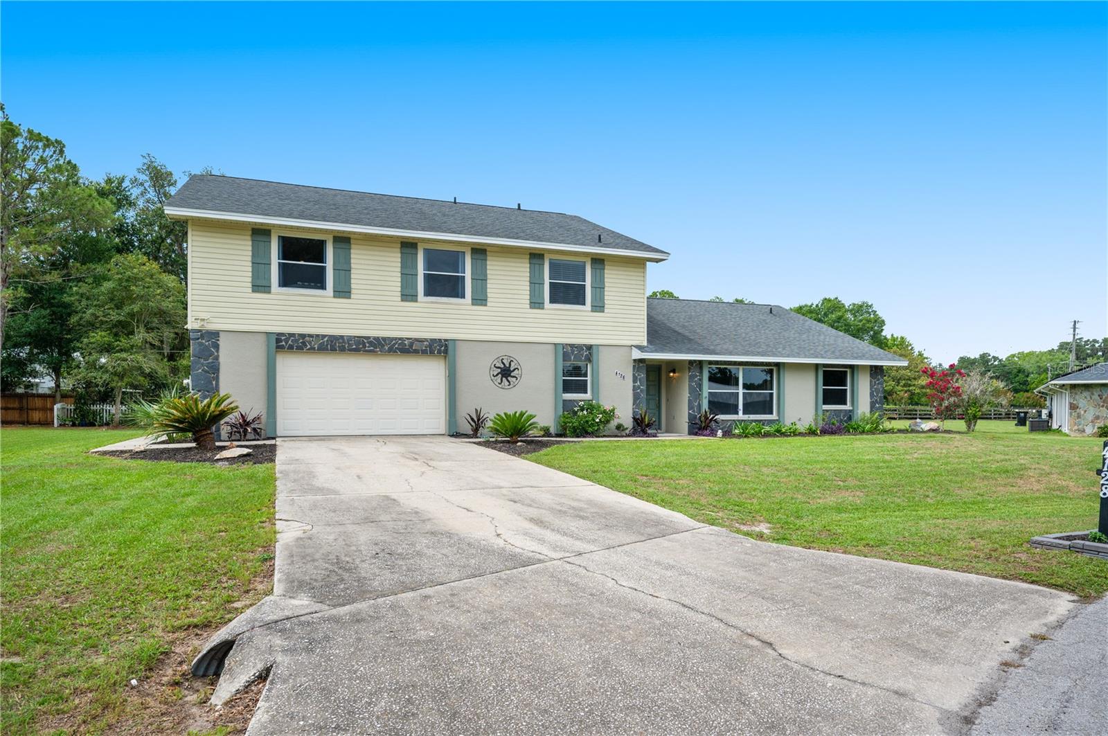 Welcome to this spacious and beautifully maintained two-story home offering over 3,300 square feet of living space, 5 bedrooms, 4 bathrooms, and plenty of room for everyone.

The heart of the home is the gourmet kitchen, featuring granite countertops, abundant cabinetry, professional-grade appliances, and a large walk-in pantry. Whether you're preparing a family meal or hosting friends, you'll appreciate the generous workspace and thoughtful layout. The adjoining living and dining areas provide plenty of room for gatherings, creating a warm and inviting atmosphere throughout the home.

Upstairs, you'll find the spacious primary suite, offering a private retreat with two large closets and a bright en-suite bathroom complete with a walk-in shower. Two additional bedrooms and an impressive 20x23 family room provide incredible flexibility for a media room, game room, home office, or additional living space.

The main level features two additional bedrooms and two full bathrooms, making it ideal for guests or multi-generational living. Throughout the home, you'll find an abundance of storage and spacious rooms designed for comfortable everyday living.

Step outside to the spacious lanai, where you'll have plenty of room to relax, entertain, or simply enjoy a quiet cup of coffee before starting your day. The drive-through garage offers ample room for vehicles, hobbies, and additional storage, adding even more functionality to this exceptional property.

And be sure to check out the oversized laundry room, complete with generous counter space, a storage closet, and a utility sink—making everyday chores a little easier.

Additional updates include a newer roof and two Trane air conditioning systems installed in 2019, providing added peace of mind for years to come.

Conveniently located between Tampa and Orlando, this move-in ready home offers the perfect combination of space, comfort, and versatility. Homes with this much room, storage, and flexibility don't come along often.