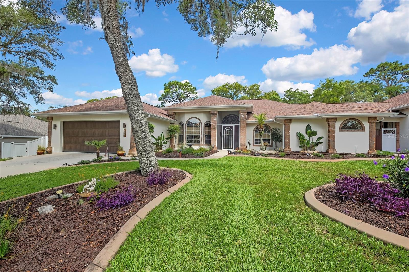 Stunning Pool Home on a Beautiful Double Lot – Room for Everything! Nestled on a beautifully landscaped .75-acre double lot, this move-in-ready property offers the perfect blend of design, function, and lifestyle. Featuring 3 bedrooms, 2 bathrooms, a 2-car garage, and a private office/den, this home has space for everyone and everything. Step inside to an open-concept floor plan designed for entertaining, featuring a beautiful kitchen with granite countertops, stainless steel appliances, and plenty of room to gather. Outside, relax and enjoy your own private pool oasis surrounded by lush landscaping. On the lot right next door, you’ll find an impressive detached 3-car garage with a studio apartment complete with its own private driveway and entrance—ideal for guests, a home business, multigenerational living, rental income potential, or extra workspace. Enjoy peace of mind with major updates including a 2021 roof, 2014 A/C, and a newer water heater—all located in a NO FLOOD ZONE. Conveniently located near the Gulf, area lakes, the new Suncoast Parkway Extension, shopping, restaurants, and more, this centrally located property offers the best of Florida living. Homes with this much space, flexibility, and garage/storage potential don’t come along often—schedule your showing today! Please note the main home is 2215 sq ft 3 bed 2 bath 2 Car garage and the studio portion located in the 3 car detached garage is 500 sq ft 1 bed 1 bath.