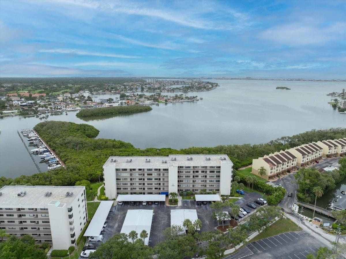 One or more photo(s) has been virtually staged. Opportunity awaits in the sought-after waterfront community of Pasadena Cove. This ground-floor, 2-bedroom, 2-bath residence offers a comfortable split-bedroom floor plan, a spacious primary suite with walk-in closet, in-unit laundry, and a screened patio perfect for enjoying Florida's year-round sunshine. The home is ready for its next chapter and presents an excellent opportunity for a new owner to personalize the interior to reflect their own style and vision. With over 1,000 square feet of living space and a desirable first-floor location, the possibilities are endless. Pasadena Cove residents enjoy a resort-style lifestyle with gated entry, a waterfront clubhouse, heated pool and spa, fitness center, marina access, walking paths, and a full calendar of community activities. Ideally located just minutes from St. Pete Beach, downtown St. Petersburg, shopping, dining, and everyday conveniences. This is your chance to own in one of South Pasadena's most desirable waterfront communities.