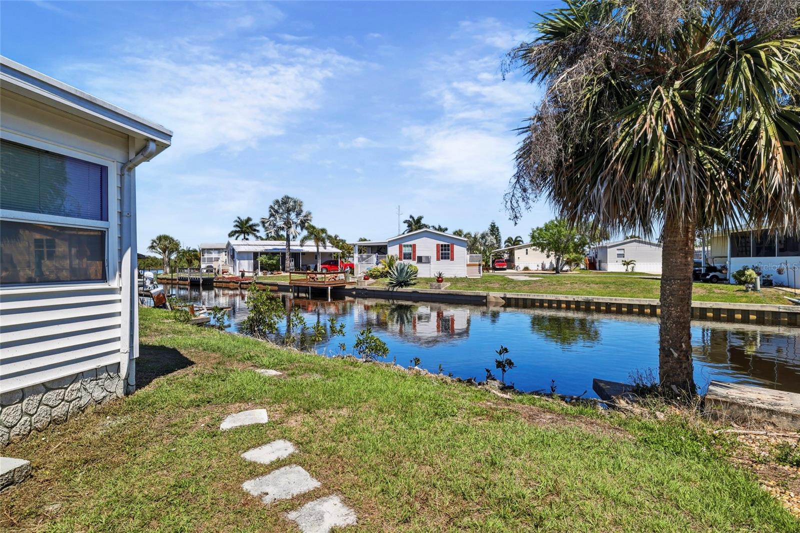 Effortless Waterfront Living — The Condo Alternative You've Been Waiting For!
Skip the high condo fees and the crowded high-rises — this completely renovated, move-in ready waterfront home in the quaint 55+ community of Pelican Harbor delivers the Florida lifestyle you've been dreaming of at a fraction of the cost. With direct saltwater canal access, no fixed bridges, and 41 feet of water frontage right outside your door, every day feels like a vacation.
Inside, you'll find a beautifully updated interior that is truly turnkey — [add your specific finishes here]. Nothing has been overlooked. Updated electrical panel (2019), new TPO membrane roof (2021), and a freshly rebuilt carport (2023) mean all the heavy lifting is already done. Just move in and start enjoying the water.
Pelican Harbor is one of SWFL's best-kept secrets — a peaceful, well-maintained community where neighbors know each other and the pace of life is exactly what Southwest Florida is supposed to feel like. Your low $145/month HOA covers water, sewer, pool, and access to the clubhouse, shuffleboard, and horseshoe pits. Golf carts are welcome, and secure boat and RV storage is available — amenities that most condos simply can't match.
Minutes to downtown Punta Gorda, Fishermen's Village, Sunseeker Resort, and Punta Gorda Airport. By boat, Charlotte Harbor and the Peace River are right at your fingertips. If you've been searching for low-maintenance waterfront living without the condo compromises, your search ends here.