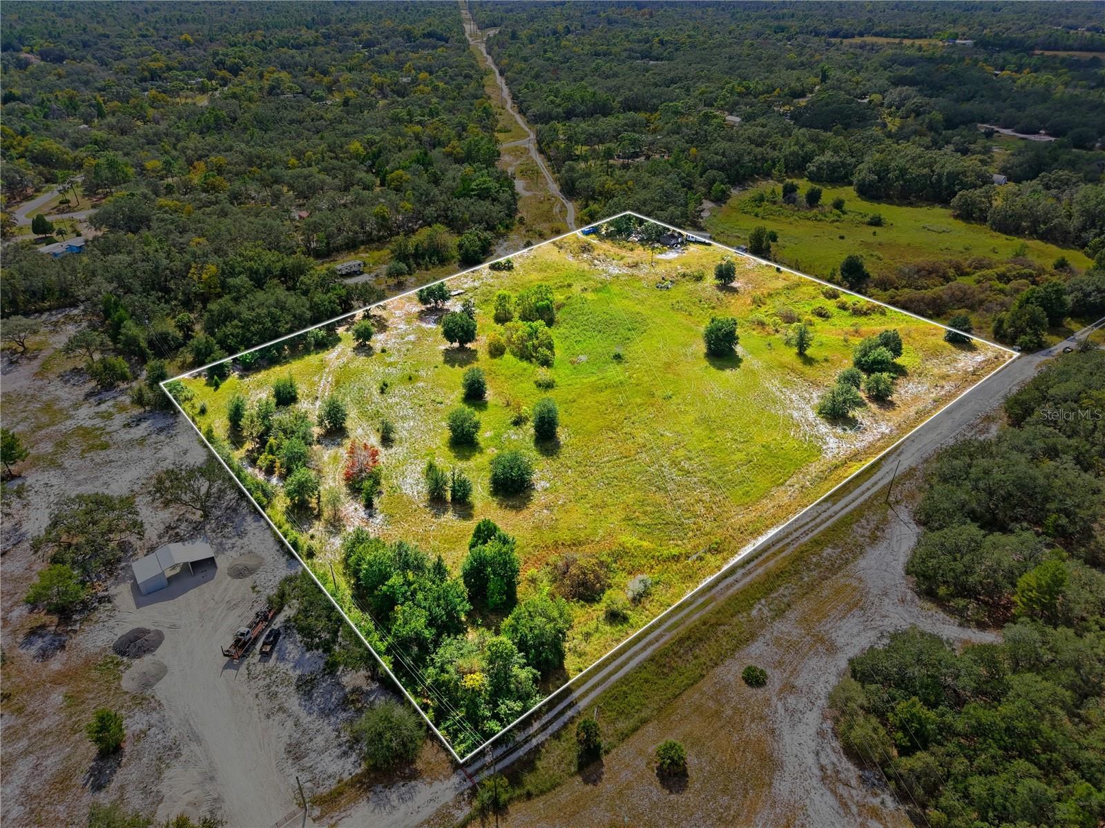 Nestled in the heart of Spring Hill, this beautiful 10-acre vacant lot offers the perfect opportunity to build your dream home surrounded by nature and tranquility. Enjoy the peace and privacy of country living while still being just minutes from shopping, hospitals, and restaurants - giving you the best of both worlds. The property is already equipped with a well, power pole, and septic tank, making it even easier to bring your vision to life. With ample space to design your ideal retreat, there’s plenty of room to store boats, ATVs, or even an RV, and still have space to explore or create outdoor recreational areas. Whether you envision a custom estate, hobby farm, or private getaway, this expansive property provides endless possibilities in a prime location. Experience country living with city convenience - your dream property awaits in Spring Hill!