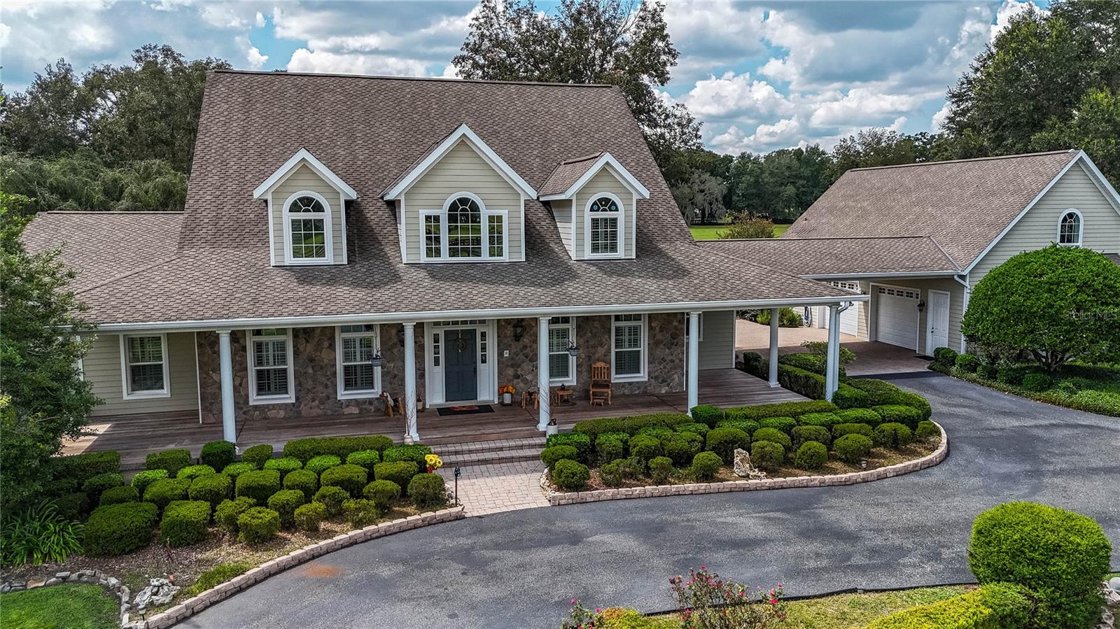 Welcome to this stunning 5-bedroom, 6-bathroom, 4,871 SF (8691 total) custom American Farmhouse on 10.5 acres in the gated community of Equine Estates. Built by Mega Construction in 2006, this exceptional home is crafted for those who value fine craftsmanship, privacy, and an equestrian lifestyle. Enjoy direct access to the 110-mile Marjorie Harris Carr Cross Florida Greenway—ride straight from your property to the Florida Horse Park, or explore three miles of private community bridle paths beneath majestic granddaddy oaks.

Main Residence: 

Showcasing timeless design and top of the line materials with all original receipts. The exterior features Hardie board siding, stone veneer accents, a steep gable roof, dormer windows and a large welcoming Brazilian hardwood porch with columns. Step into the two-story coral stone foyer, where a custom red oak staircase and balcony rail set an elegant tone carried throughout the home.

The great room impresses with a cathedral beamed tray ceiling and an architectural stone floor-to-ceiling handcrafted fireplace  complemented by a towering custom red oak entertainment center that echoes the home’s stunning staircase and flooring. 

The gourmet kitchen is a chef’s dream—granite countertops, shaker cabinetry, coral stone floors, pendant lighting, dual pantries, and island seating. A laundry room off the kitchen continues the fine craftsmanship with matching shaker cabinetry and coral stone flooring. The   kitchen has an eat-in area, plus an additional formal dining or secondary kitchen space off the great room—

The primary suite is a true retreat with red oak flooring, plantation shutters, a serene sitting retreat overlooking the pool and pastures and a spa-inspired bath featuring coral stone floors, dual stone vanities, a soaking tub encased in stone, and a glass shower with coral stone flooring.

Upstairs, three spacious ensuite bedrooms feature Kohler fixtures, Corian vanities, and frameless glass showers, while an additional 810-square-foot finished space above the three-car garage with a private entrance and half bath providing a perfect gym, office, or guest suite.

Outdoor Living:

Step through the French doors to a vaulted, screened lanai wrapped in rich Brazilian hardwood decking, where a warm oak ceiling and a floor-to-ceiling stone fireplace—designed for both gas and wood burning—create the perfect backdrop for every season. The lanai offers a picturesque vantage point overlooking the saltwater pool, horse barn, and sunlit pastures.

Equestrian Barn:

The 2,548-square-foot center isle block barn is designed for function and comfort, featuring four stalls, an Air conditioned tack and feed room, two hot/cold wash racks, a shoo fly system and a dedicated equipment room featuring workbenches and shelving along with a climate-controlled office with half bath providing convenience and comfort.

The property’s lush 10.5-acre pastures are fully fenced and cross fenced, offering an ideal setup for horses and cattle.

Modern Systems & Features:

5-unit multi-zone HVAC (2 new 2025; 4 home + 1 barn office)-

Whole-house Generac generator (July 2025 service)-

Dual propane tanks-

Updated water heaters, bladder tank (2024), irrigation (2025 panel)-

NuTone central vac, 10-year termite bond (to 2035)-

Porte-cochère with 30-amp RV hookup for vehicles or guest use.
