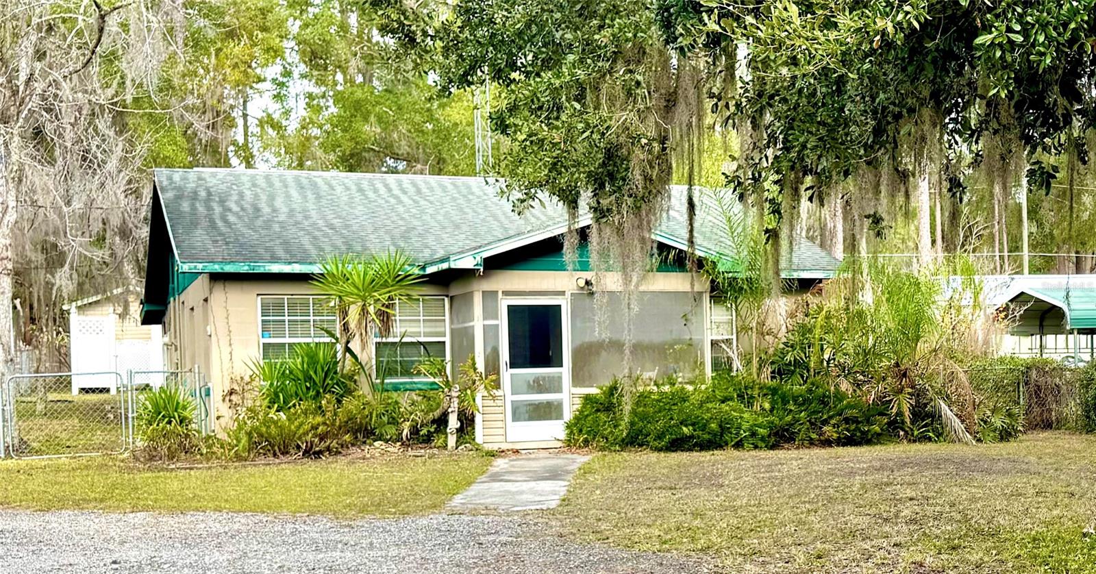 Waterfront bungalow on a CANAL leading to beautiful LAKE KERR! This charming 2-bedroom, 2-bath home is full of character and functionality, featuring a WHOLE HOUSE GENERATOR for peace of mind during those stormy weather nights. Inside, you’ll find a spacious family room, a desirable split floor plan, a large primary suite with a private en-suite bath, and a second full bath conveniently located at the rear of the home. The home also showcases its ORIGINAL 1950s kitchen complete with a gas cooktop. In this home all appliances convey, including two refrigerators (one with an ice maker), a washer and dryer, a dishwasher, a microwave, a convection toaster oven, and a toaster—making this home truly move-in ready! Outside, the property offers a large workshop, a detached laundry room, and two sheds. The larger shed includes an attached carport, and even the riding mower conveys with the sale! Whether you’re looking for a full-time residence, a weekend getaway, or an excellent Airbnb opportunity, this one-of-a-kind canal-front home checks all the boxes! Call today to make it yours!