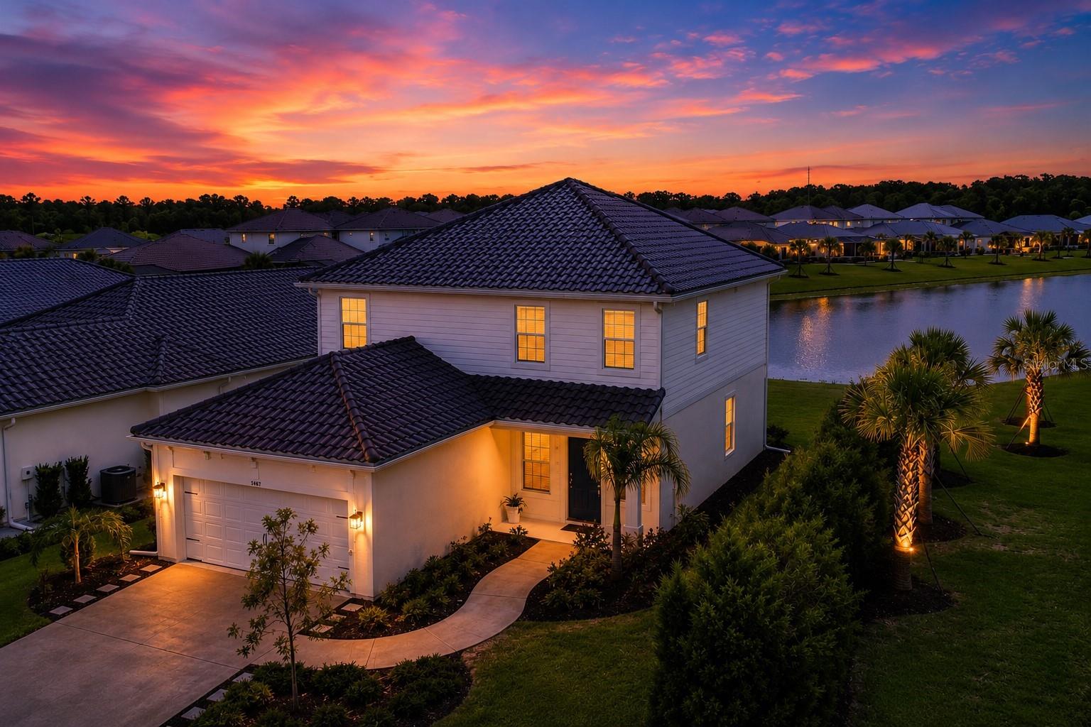 18K Price enhancement. Let's Go! Practically new with a beautiful view! Make your way to Grand Park by Neal Communities, a masterfully designed amenity rich community, and soak in the charm the moment your enter. Meander through expansive green areas, pass state of the art amenities, and find your way home. This lovely home perches on a long view waterfront that is private and boasts western exposure for colorful evening skies.  Nearly 2,200 sf is comprised 3 bedrooms upstairs, a loft, a flex room and a rare opportunity for the 3 car tandem garage. Fantastic curb appeal welcomes you home. The first floor is all about the living space. Open concept with enormous great room that connects to an open dining room and kitchen that is light and bright all with views to the blue outback. Kitchen has modern quartz, extended island with counter top seating, stainless steel appliances, gas stove, and slider access to the covered patio. Also you'll find a flex room with French doors that can be used for anything, walk in pantry, breeze room, and wood look planking flows throughout the home. Take to the upstairs where your loft is centered amongst the bedrooms. Large ensuite with dual vanities and walk in shower. Dedicated laundry centrally located for added convenience. Find something for everyone in Grand Park. Incredible location, minutes from the interstate and a dream list of things to do from swimming to basketball, pickle ball, tennis, dog parks, soccer fields, workout center, playgrounds, clubhouse, greens spaces connected by trails, tons of activities and all of this is within walking distance to your front door. A rated Sky Ranch K-8 school with top notch STEAM program just minutes away. Come visit today by scheduling a private showing.