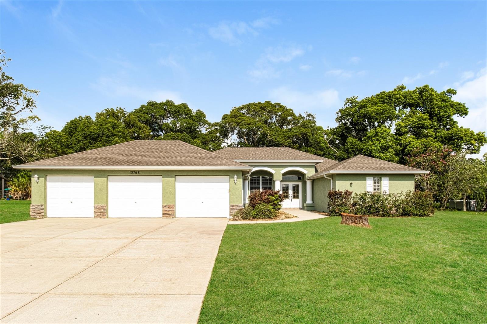 Virtually Staged. Welcome to this home located in the Plantation Estates! This spacious 3-bedroom, 2-bathroom home offers 2,526 square feet of comfortable living space and sits on a large lot with a desirable three-car garage. The kitchen is designed for both functionality and entertaining, featuring abundant cabinet storage, granite countertops, a breakfast bar, and stainless steel appliances. The inviting living room is highlighted by a cozy fireplace, creating the perfect gathering space for family and friends. Step outside to the expansive screened-in patio, ideal for relaxing or enjoying outdoor dining year-round. With fresh exterior paint and plenty of room both inside and out, this home is ready for its next owner to enjoy.