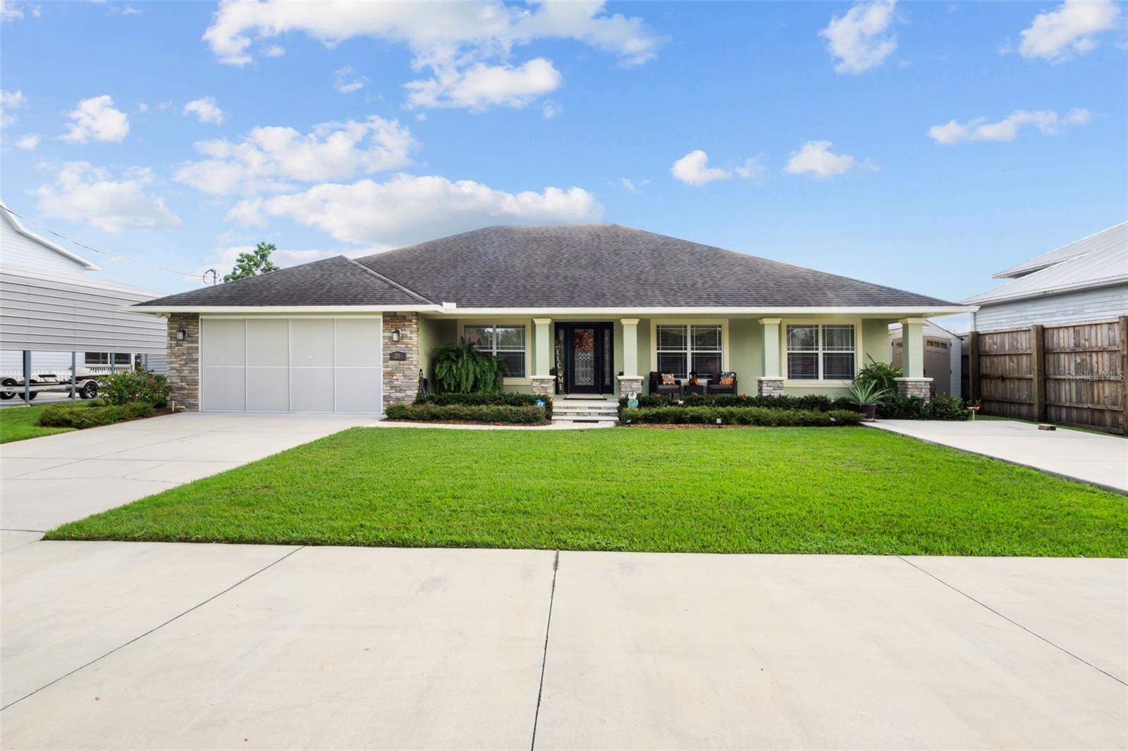 Beautiful canal front pool home on Lake Hatchineha and the Kissimmee Chain of Lakes with access to Lake Tahoe some of the best freshwater fishing in the state.  Pristine exterior with landscaped grounds and a welcoming front porch lead to the homes spacious interior with tile flooring , high ceilings and an upgraded feel throughout.  This 3 bedroom, 2.5 bath waterfront pool home is located in a quiet fishing community and makes for the perfect full time, part-time or vacation rental property for income potential.  Comfortably sized great room with water views opens to the beautiful kitchen with quality cabinetry, solid surface counters, stainless appliances, breakfast bar and dinette.  Formal living and dining  rooms allow for ease of entertaining with family and friends.  Master suite features a tray ceiling, huge walk-in closet, french doors to lanai and an elegant master bath with soaking tub and tiled walk in shower.  Guest bedrooms are both generously sized with easy bathroom access.  Screened back porch overlooks in ground pool with pavers, 50 x 20 covered dock set up with two covered boat lifts, entertaining area for dining.  Other notable features include central vacuum, two car garage, screen garage door, two driveways perfect for RV or boat trailer parking, inside laundry, fenced backyard, canal fed irrigation, generator hook up and so much more. Come experience Lake Hatchineha and the Kissimmee Chain of Lakes.
