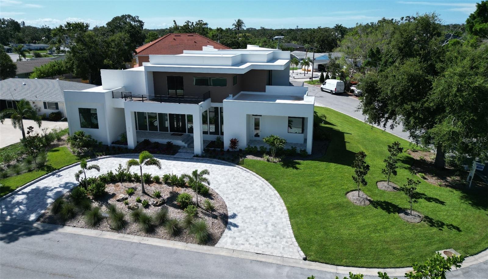 OPEN, FLEXIBLE FLOOR PLAN designed to accommodate a variety of wishes and needs. New custom luxury home for sale in Sarasota Florida located on Coquina Island. This high-end Sarasota luxury estate features a private in-law suite, resort-style pool and spa, outdoor kitchen, and over 4,000 square feet of modern coastal living.
One of a kind design to optimize the homesite, is located in the heart of Sarasota County offering luxury & timeless contemporary design. Just minutes from Phillippi Mansion Park, Siesta Key Beach, top-tier shopping, dining, Sarasota Memorial Hospital, Selby Gardens, and downtown Sarasota, this home enjoys a prime location.

Key Features:

5 Bedrooms | 5 1/2 Bathrooms.
38' Wide Polyaspartic Garage with high ceilings, music speakers and 2 ceiling fans (space allows lifts in each bay).
13' High Ceilings in the great room.
Gourmet Kitchen with sleek appliances, large island, cooktop hood, double wall ovens, coffee bar, and an expansive walk-in pantry with custom shelving and room for a full freezer or refrigerator.  Truly a chef's delight!
Spacious Master Suite with paver deck on main floor, his and hers huge walk-in custom closets, ensuite luxury bath.
Private multiple decks and a large paver lanai overlooking the Pebble-Tec heated saltwater pool with spillover spa and outdoor kitchen
Separate In Law Suite above the garage with a great room, full kitchen, bath, bedroom, laundry room, and balcony.
Energy Efficient with Icynene insulation, soundproofed walls, and potential for solar power or generator.
3 HVAC units and zones.
Instant hot water heater; separate water heater for in law suite, tankless hot water heater as well in main living spaces.

Interior Highlights:

High-end finishes and 2 custom-built open staircases.
Wood and tile floors throughout.
Floor-to-ceiling windows flood the home with natural light.
Fully structured wiring for sound; 19 music speakers and 8 security cameras.
Large laundry room with custom cabinetry, laundry sink, stone folding counter and hanging rod.
Spacious pantry with custom shelves; electric dedicated circuit for additional freezer or refrigerator.
Insulation in walls & ceiling for sound mitigation.
WiFi mesh inside & out.

Outdoor Oasis:

Heated Saltwater Pool & Spa with spillover waterfall and floor clean system.
8 Security cameras.
Outdoor Kitchen featuring marine-grade cabinets.
Professionally designed tropical gardens with private well for the sprinkler system.
LED Lit Circle Paver Driveway adds striking curb appeal.

The home has been specifically designed for its setting, with eye appeal on all sides.  Too many extra features to list!  It is in a very quiet neighborhood, yet close to Sarasota.  You will not be disappointed in this home!