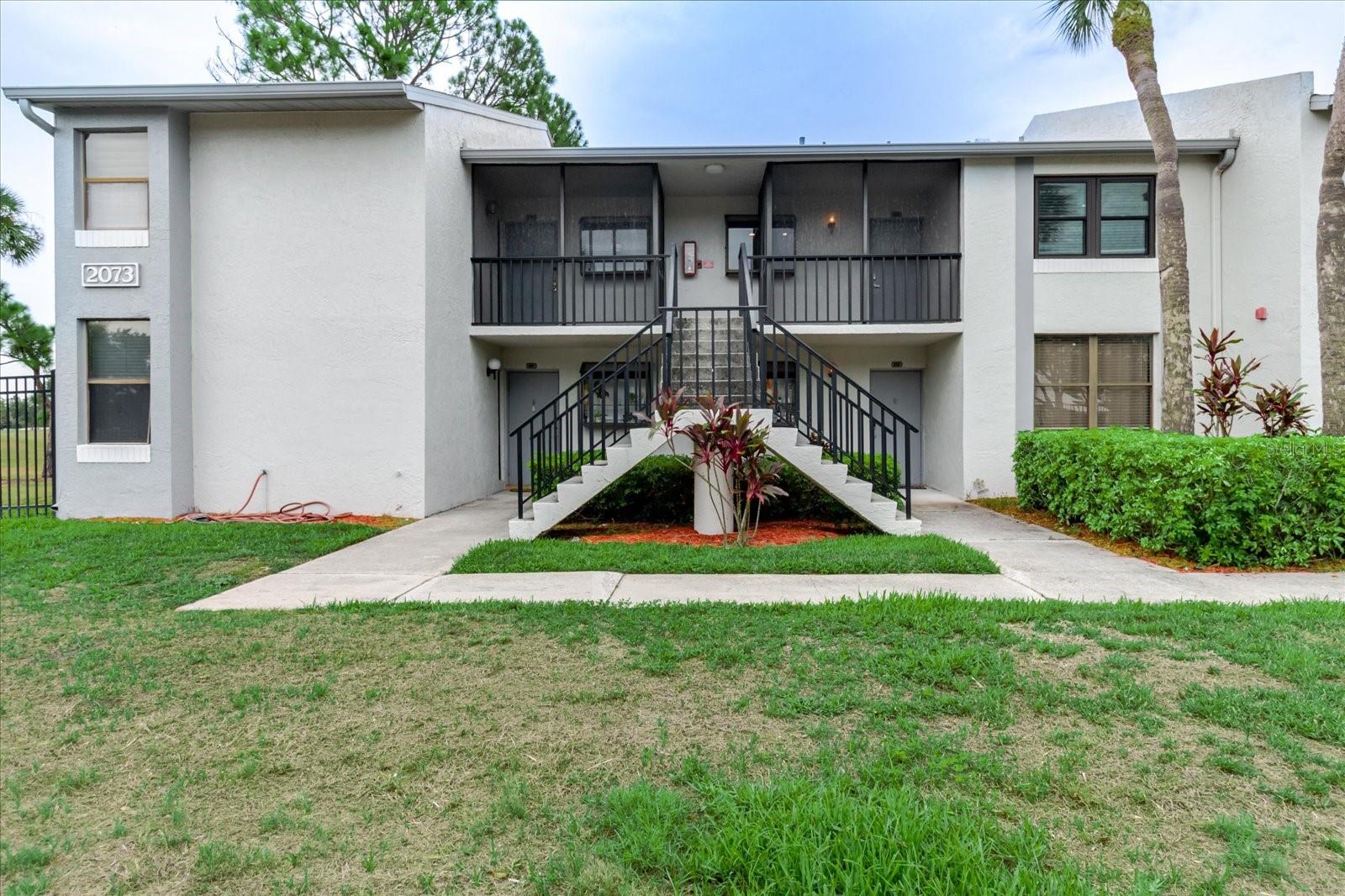 Welcome to resort-style living in the gated community of The Club at Feather Sound! This extensively renovated 2-bedroom, 2-bath condo offers picturesque golf course and lake views from the screened balcony and a thoughtfully redesigned open floor plan. The stunning kitchen features soft-close shaker cabinetry, quartz countertops, stainless steel appliances, a glass tile backsplash, oversized breakfast bar with seating, built-in wine refrigerator, and abundant storage. Tile flooring flows throughout, complemented by recessed lighting, beautifully remodeled bathrooms, new windows, and new sliding glass doors. An extensive renovation completed in 2021 by licensed contractors with county permits included new electrical, plumbing, drywall, ductwork, tile flooring, kitchen, bathrooms, water heater, interior doors, trim, windows, and appliances. The A/C was replaced in 2026 for added peace of mind. Enjoy exceptional community amenities including a  heated pool, spa, clubhouse, fitness center, indoor basketball court, tennis courts, outdoor grilling area, and beautifully maintained grounds. Ideally situated just minutes from I-275, Tampa International Airport, St. Pete-Clearwater International Airport, shopping, dining, downtown St. Petersburg, and Florida's award-winning Gulf beaches.