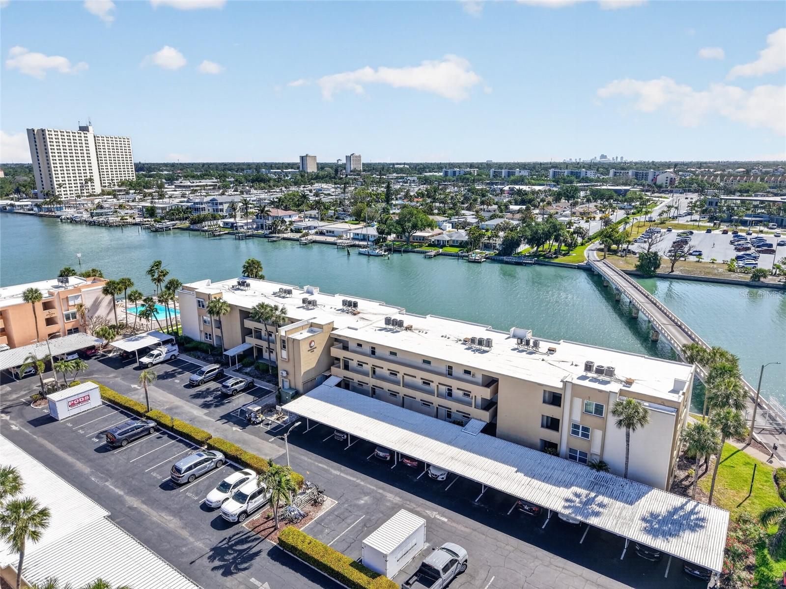 One or more photo(s) has been virtually staged. Modern Waterfront Sanctuary in Bay Island minutes to St. Pete Beach. Experience the ultimate coastal lifestyle in this bright and inviting 1-bedroom, 1-bathroom waterfront condo located in the Barbados Building of Bay Island. Capturing the essence of coastal living, this residence features an open-concept floor plan where oversized windows pull in natural light and frame the Intracoastal like a living panorama, giving the home a sense of space and serenity. For those prioritizing home resiliency and peace of mind, the building was updated with a new roof in 2024 and a new elevator, ensuring long-term value and convenience. This move-in-ready retreat includes assigned parking, with a brand-new carport structure scheduled for installation soon. As part of a premier 55+ gated waterfront community, residents enjoy an amenity-rich environment designed for an active and social lifestyle. The resort-style grounds feature six heated pools, four lighted tennis and pickleball courts, a newly renovated clubhouse, and a scenic 1.5-mile waterfront walking path perfect for morning strolls. Ideally situated under a mile from St. Pete Beach, you are minutes away from world-class dining, boutiques, and the pristine white sands of the Gulf. Whether you are seeking a seasonal retreat or a full-time waterfront home, this condo offers a clean, serene, and secure space in one of Pinellas County’s most sought-after coastal environments.