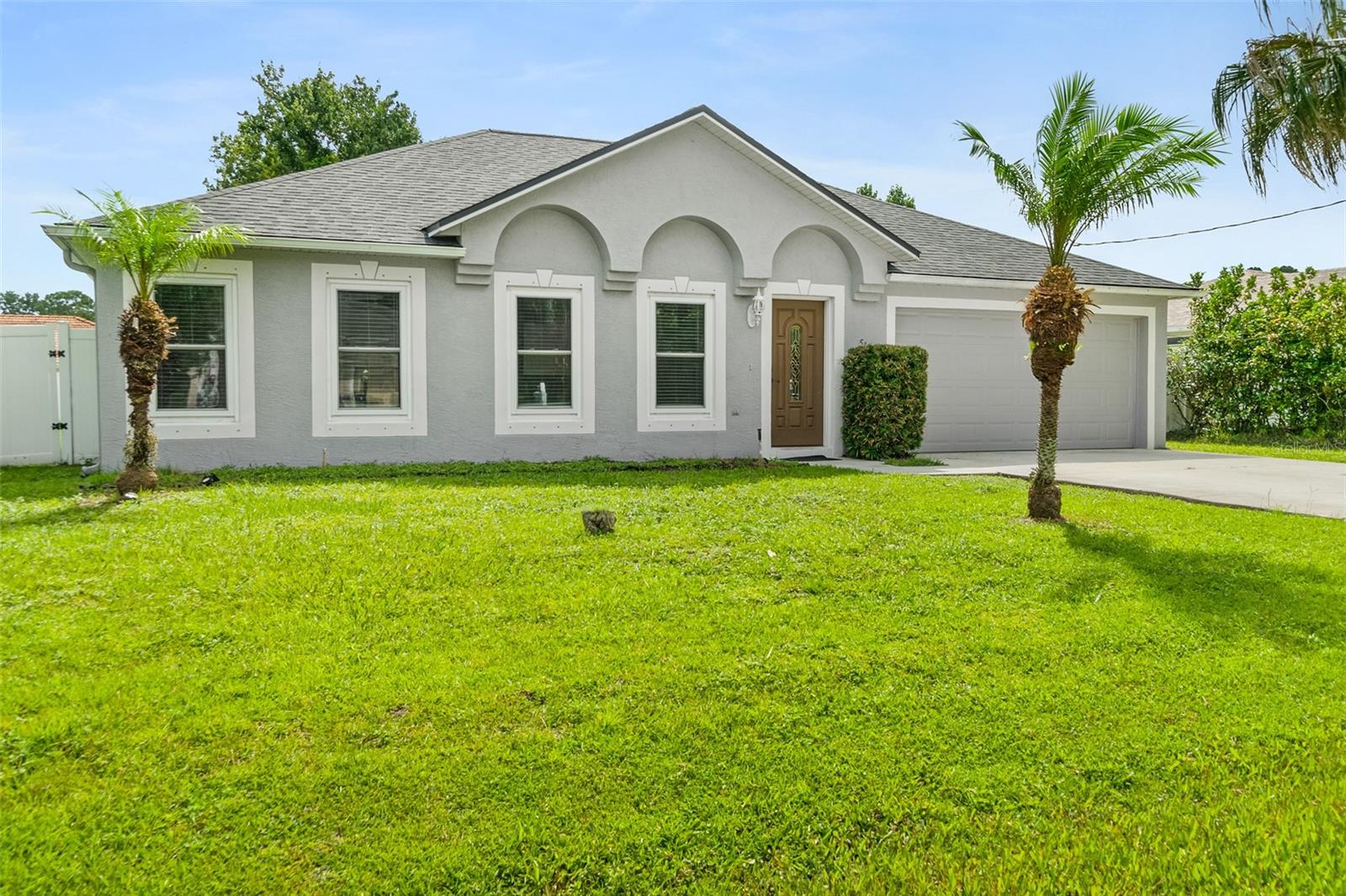 Welcome home to this well-maintained 3-bedroom, 2-bath home with a 2-car garage located in the desirable Indian Trails subdivision of Palm Coast. Offering 1,935 square feet of living space, this home features a spacious, open floor plan with tile flooring throughout the main living areas, providing both style and easy maintenance.

The kitchen is designed with functionality in mind and features a large center island with a double sink, an additional double sink, ample cabinetry, and generous counter space for meal preparation and entertaining. The open layout flows seamlessly into the living and dining areas, creating a comfortable space for everyday living and gatherings.

The primary suite includes two walk-in closets, dual vanity sinks, and a tiled walk-in shower. Two additional carpeted bedrooms and a full guest bath provide flexibility for family, guests, or a home office.

The yard is fully fenced with white vinyl fencing and is great for pets and privacy!

Enjoy the convenience of living just minutes from shopping, restaurants, medical facilities, hospitals, parks, and major roadways. The property is also located approximately 12 miles from Flagler Beach, offering easy access to the Atlantic Ocean. Palm Coast is known for its extensive network of walking and biking trails, golf courses, tennis and pickleball courts, boating, fishing, and numerous parks and recreational opportunities.

Whether you are purchasing your first home, looking for more space, downsizing, or adding to your investment portfolio, this move-in-ready property offers a functional layout and a convenient location. Buyer to verify all measurements and information deemed important.