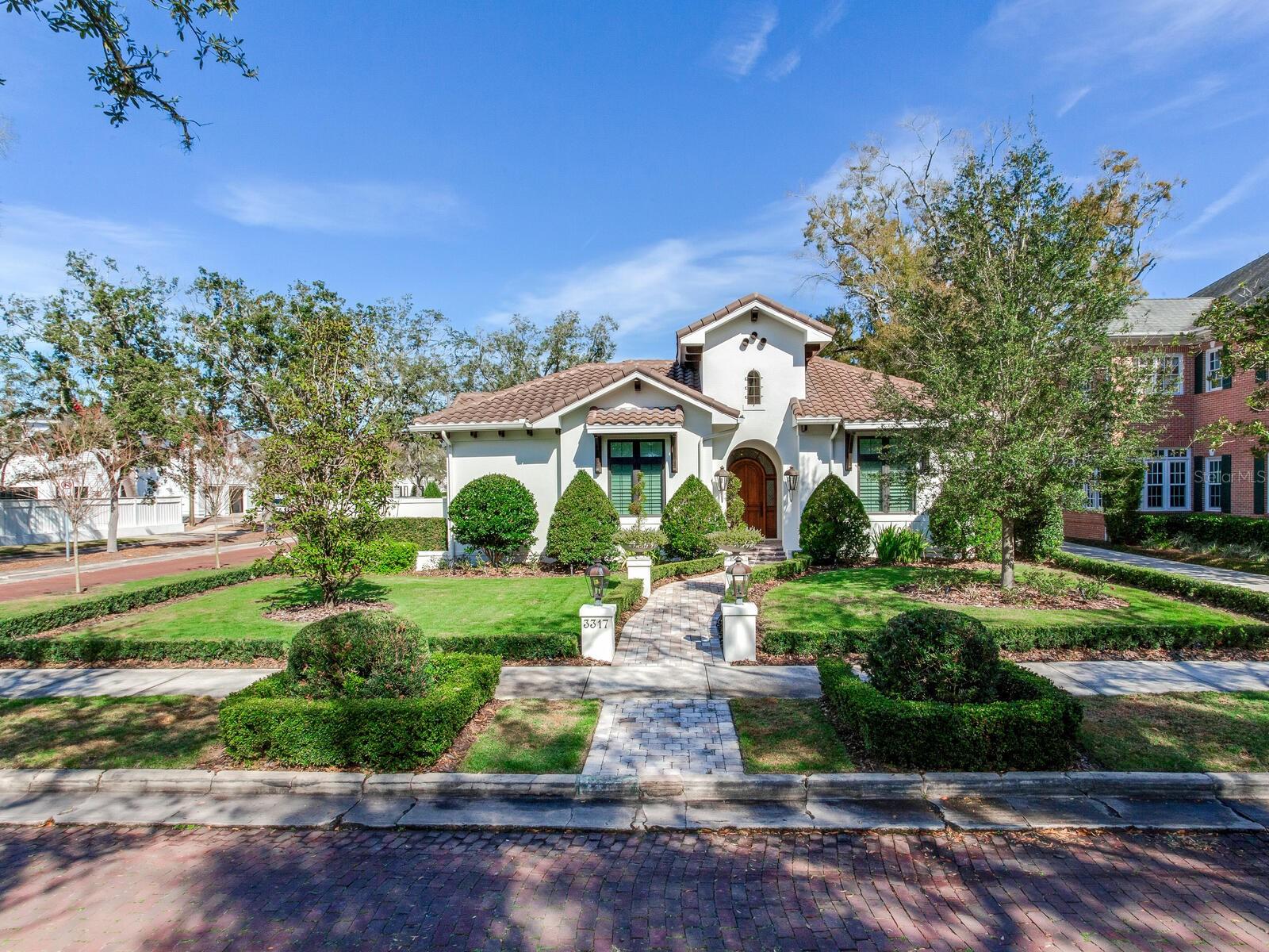 On a corner lot in Golf View and custom built-to-perfection, 3317 Mullen Ave is a charming modern Mediterranean-styled home that boasts Spanish Mission and Italian influences. Stucco walls, a tile roof, a high arched entry with an iron grill outlook window, wood-trim soffit supports, and a handsome old world solid wood four-panel arched entry door with surrounding glass trim are just some of the elements defining these influences. Inside you will enjoy the architectural scale of the rooms and the high-end finishes found throughout. A wide foyer opens into a massive great room elegantly divided into a kitchen, dining room, and living room areas ---all smartly decorated with layers of crown molding, accent columns, and tall glass windows indoors. The kitchen sports a large island, a metal old-world range hood, a built-in walk-in pantry that far surpasses most other pantries, and top of the line appliances. The master suite is substantial and sumptuous, and nothing has been spared in designing the master bath and walk in closet suite. The other bedrooms (2) are also well appointed, and the den could be a fourth bedroom handsomely incorporates an L-shaped, red, Birch bronze-stained Bank of built-in drawers of all sizes and a desk area and reading niche. Even the laundry room is pretty, and the garage is neat as a pin. If this is not enough, you will be charmed by the Spanish Hacienda styled paver patio that it is an extension of the style and symmetry of this home. The great room opens to the patio and is the full length of the side of the home and includes a built-in outdoor kitchen with grass grill and Spanish accent tiles above a gas lit fireplace area and lighted fountain and gorgeous planters. Not only is this home well-designed and beautifully appointed but it is also an Energy Star certified new home. This includes the following: the Thermal Enclosure System, the heating, cooling, and ventilation systems, the water management system and the energy efficient lighting and appliances. Also present are a gas generator, a finished attic with ventilation and wiring for the whole house audio system, TV's, and Cameras (including the patio.) This is the one-story home you've always wanted to build, but now someone else has done it for you, and it is an X flood zone. Located in the heart of South Tampa this area affords easy access to numerous dining and entertainment areas including Downtown, Channel Side, Midtown as well as easy access to Tampa International Airport and Tampa’s major Interstate thoroughfares. Call today for a floor plan and a fact sheet and a home tour.
