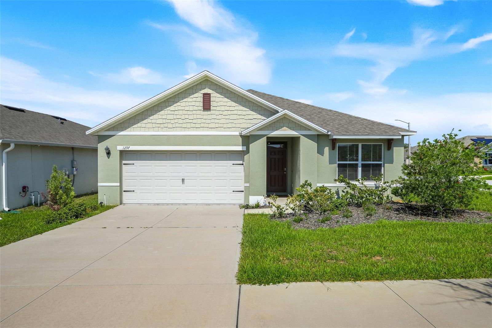 Welcome to 1297 Tagliamento Lane in Magnolia Park, a clean and well-maintained 3-bedroom, 2-bath home built in 2023 and situated on a desirable corner lot in Haines City. This single-story layout offers comfortable everyday living with an open main living area, granite countertops, and a functional kitchen that flows into the dining and living spaces. The fenced backyard adds usable outdoor space, while the custom paver patio creates a low-maintenance area for relaxing, grilling, or entertaining. The home also features a 2-car garage and a practical split-bedroom layout. Magnolia Park offers community amenities including a pool and playground, with convenient access to US-17, Hwy 27, shopping, dining, and nearby Lake Eva Community Park and Event Center. A solid option for buyers looking for a newer home with outdoor space, clean finishes, and a convenient Haines City location.